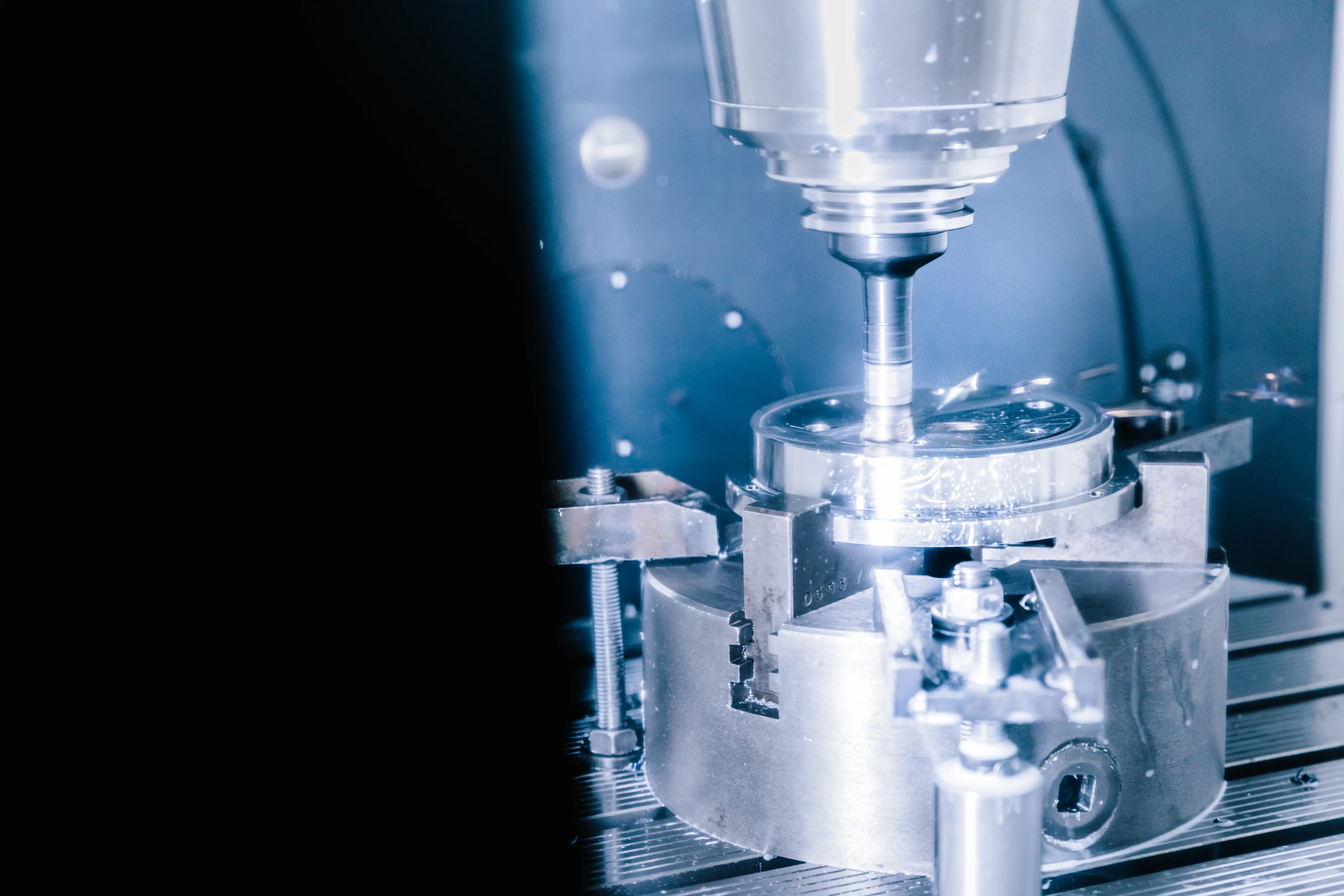 Close-up of a CNC machine milling a metal workpiece in a manufacturing setting.