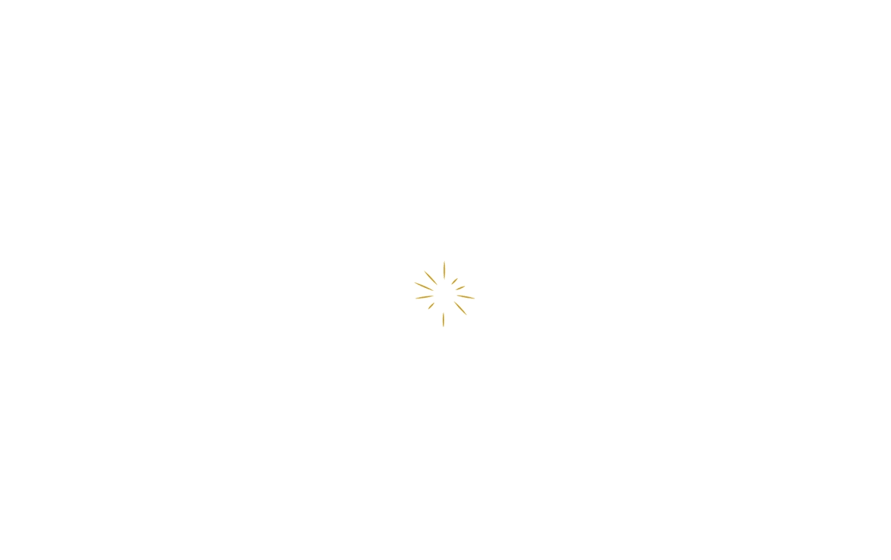 Golden apple with a shiny radiance and soft glow effect on a white background.
