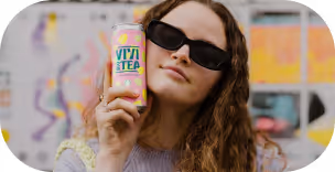 Person wearing black sunglasses holding a can of VITA TEA peach mango drink near their face.