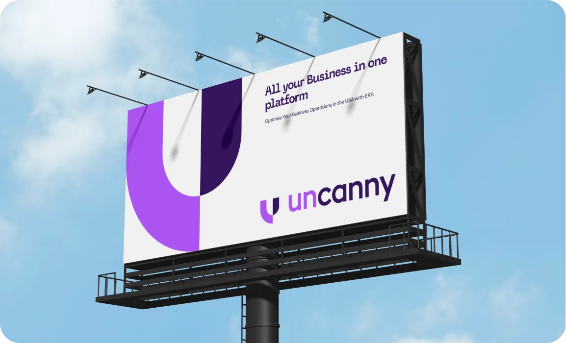 Outdoor billboard with purple and white design advertising Uncanny, promoting an all-in-one business platform with ERP for USA.