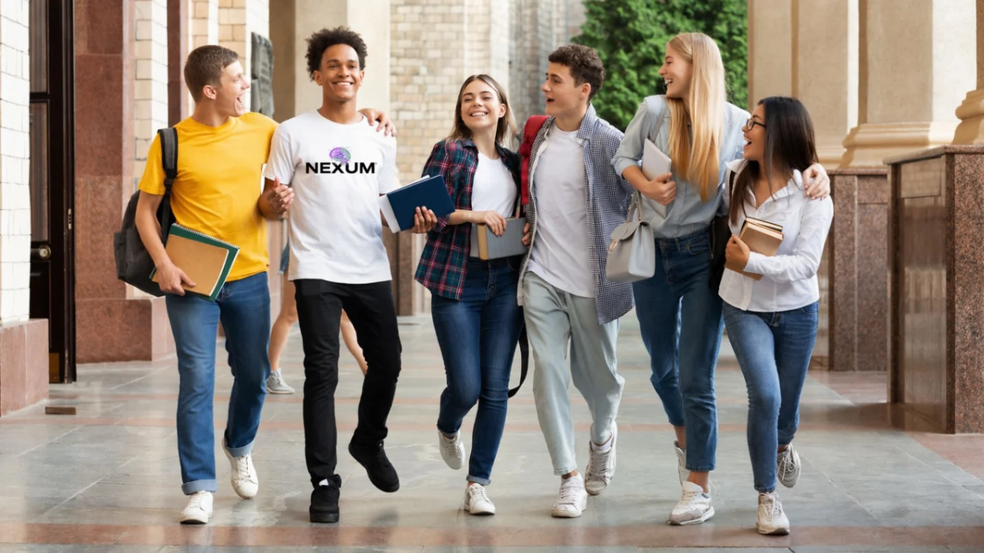 Group of six diverse students walking together happily in a campus hallway holding books and backpacks.