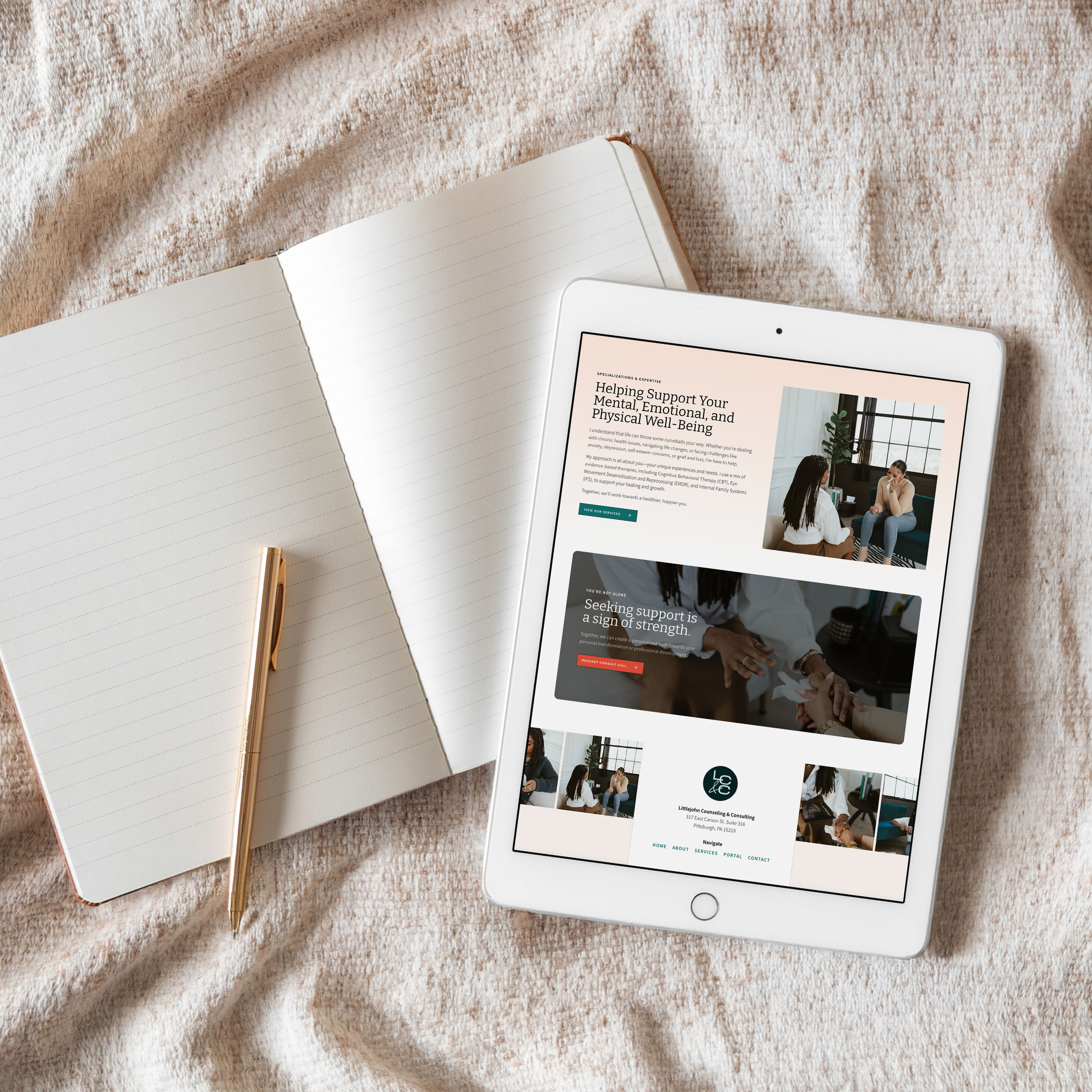 Littlejohn Counseling & Consulting website design shown on a tablet lying next to an open notebook and pen