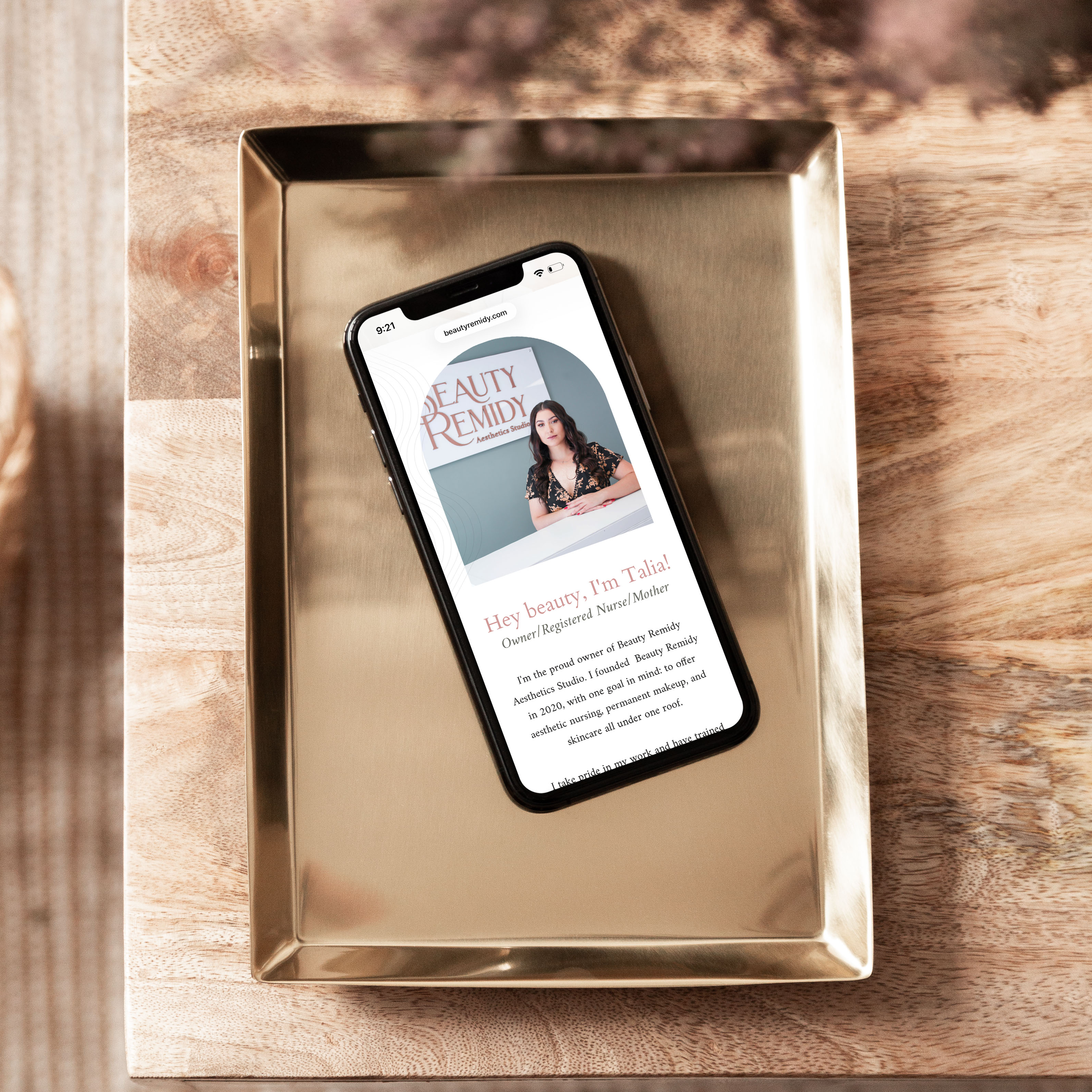 Beauty Remidy mobile website design shown on a phone on a gold tray, with the headline "Hey beauty, I'm Talia!"