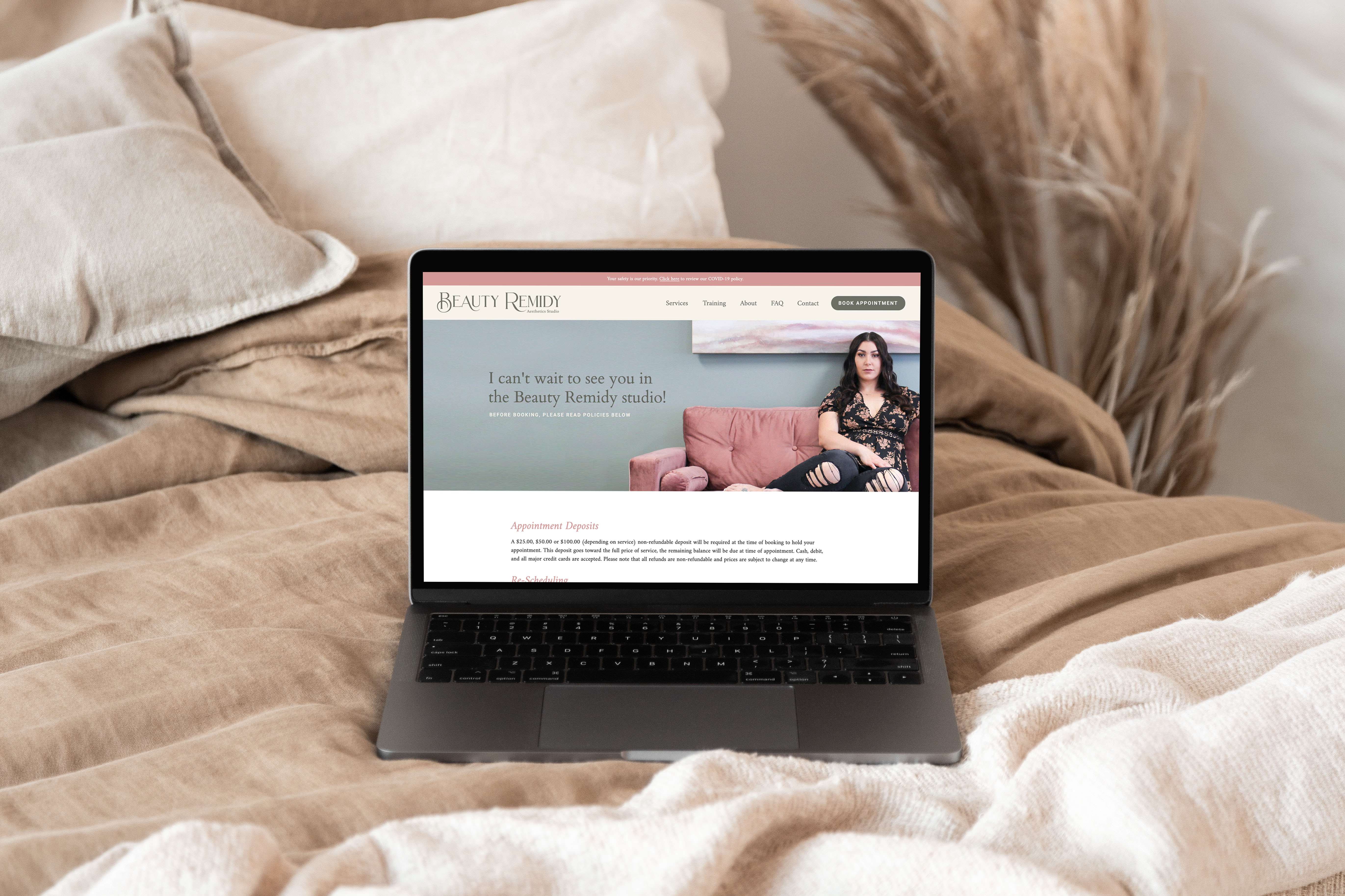 Beauty Remidy booking policies page design shown on a laptop on a bed with tan linen bedding, with the headline "I can't wait to see you in the Beauty Remidy studio!"