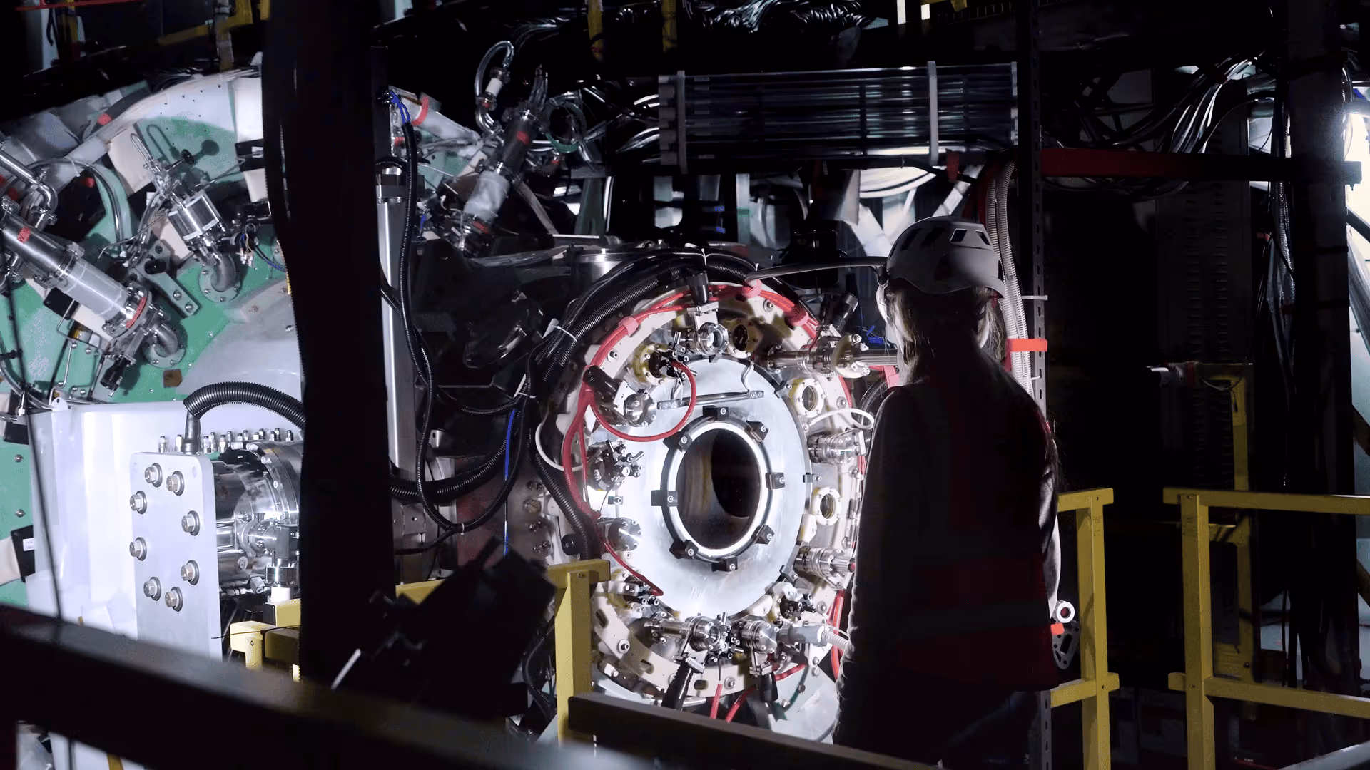 Engineer wearing a white safety helmet and vest inspecting Polaris.