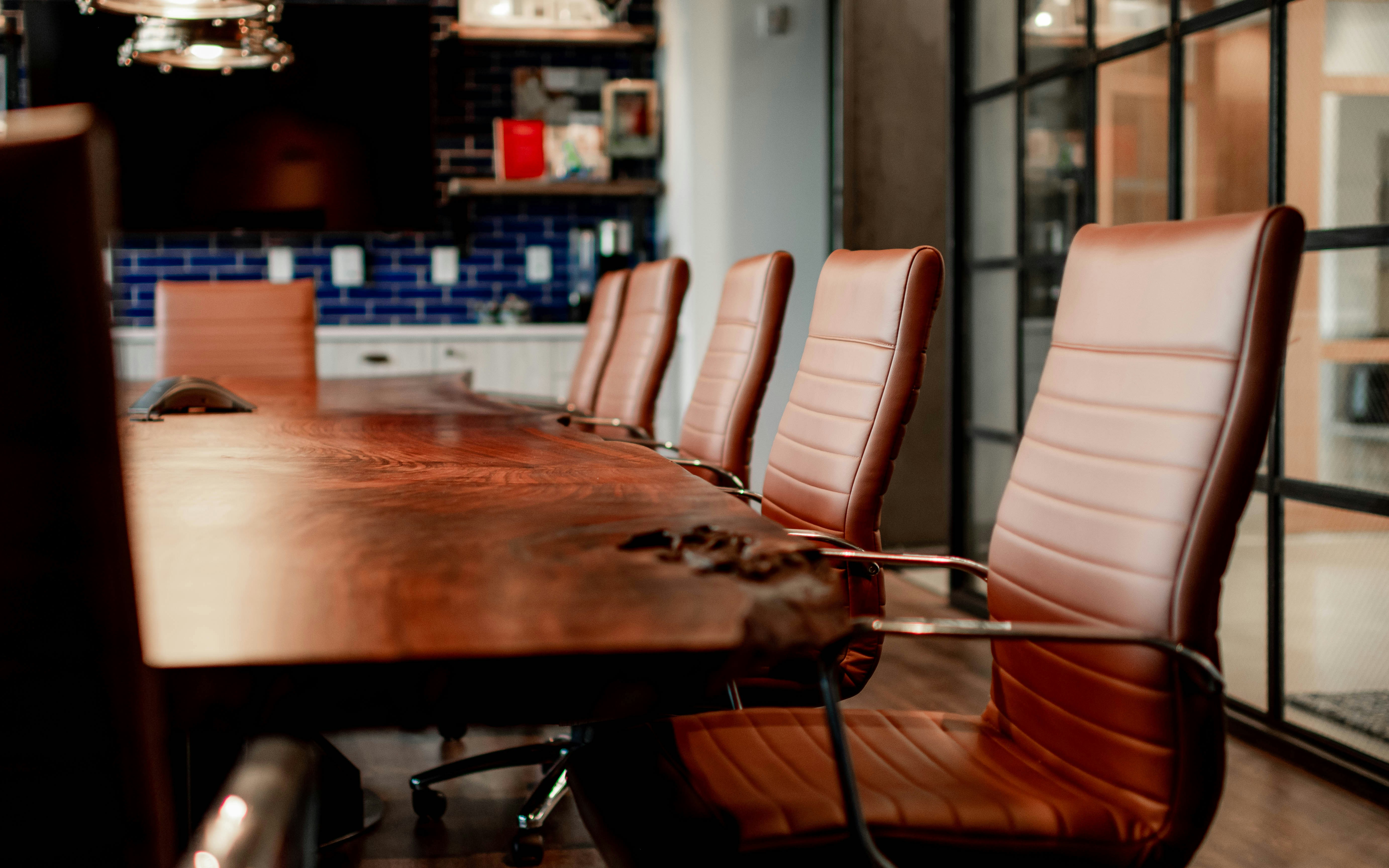 Modern executive boardroom with leather chairs and conference table
