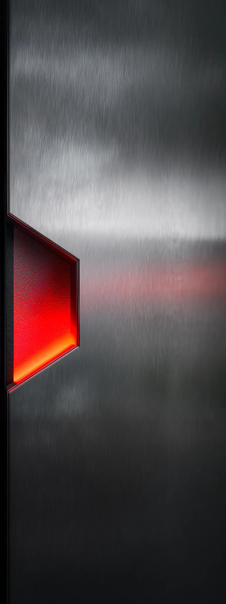 Brushed metal surface with a geometric cutout revealing a glowing red light inside.