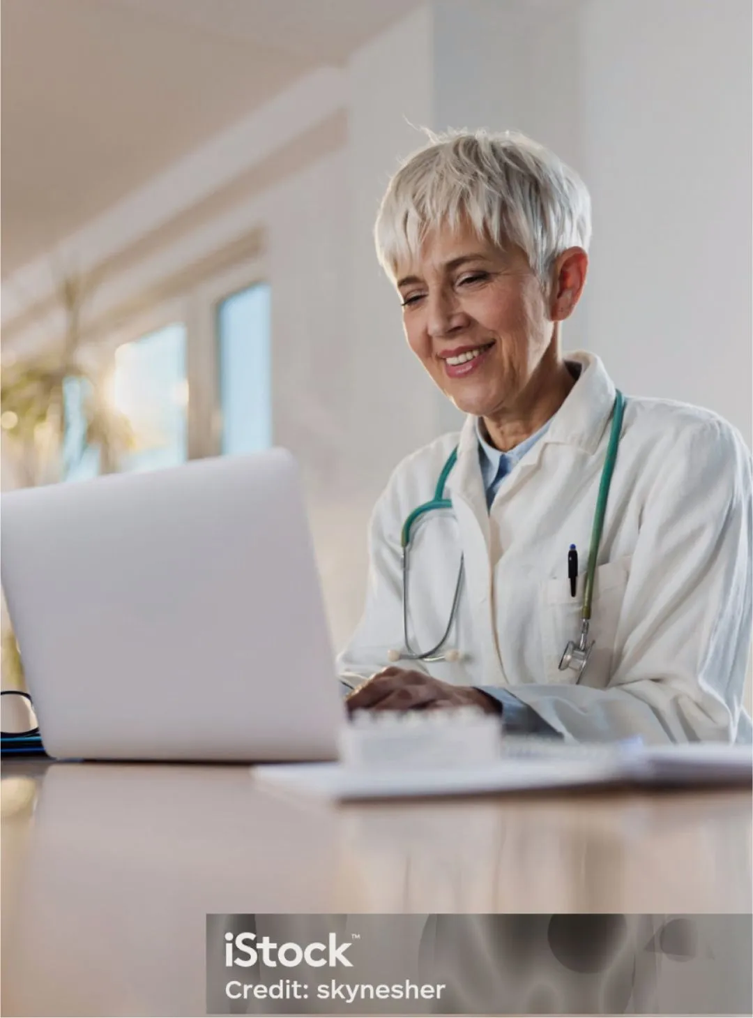 doctor smiling at a computer