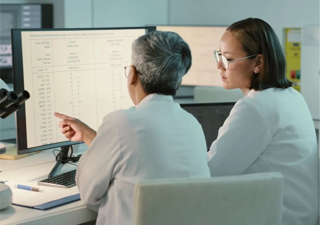 two doctors reviewing results on a computer screen