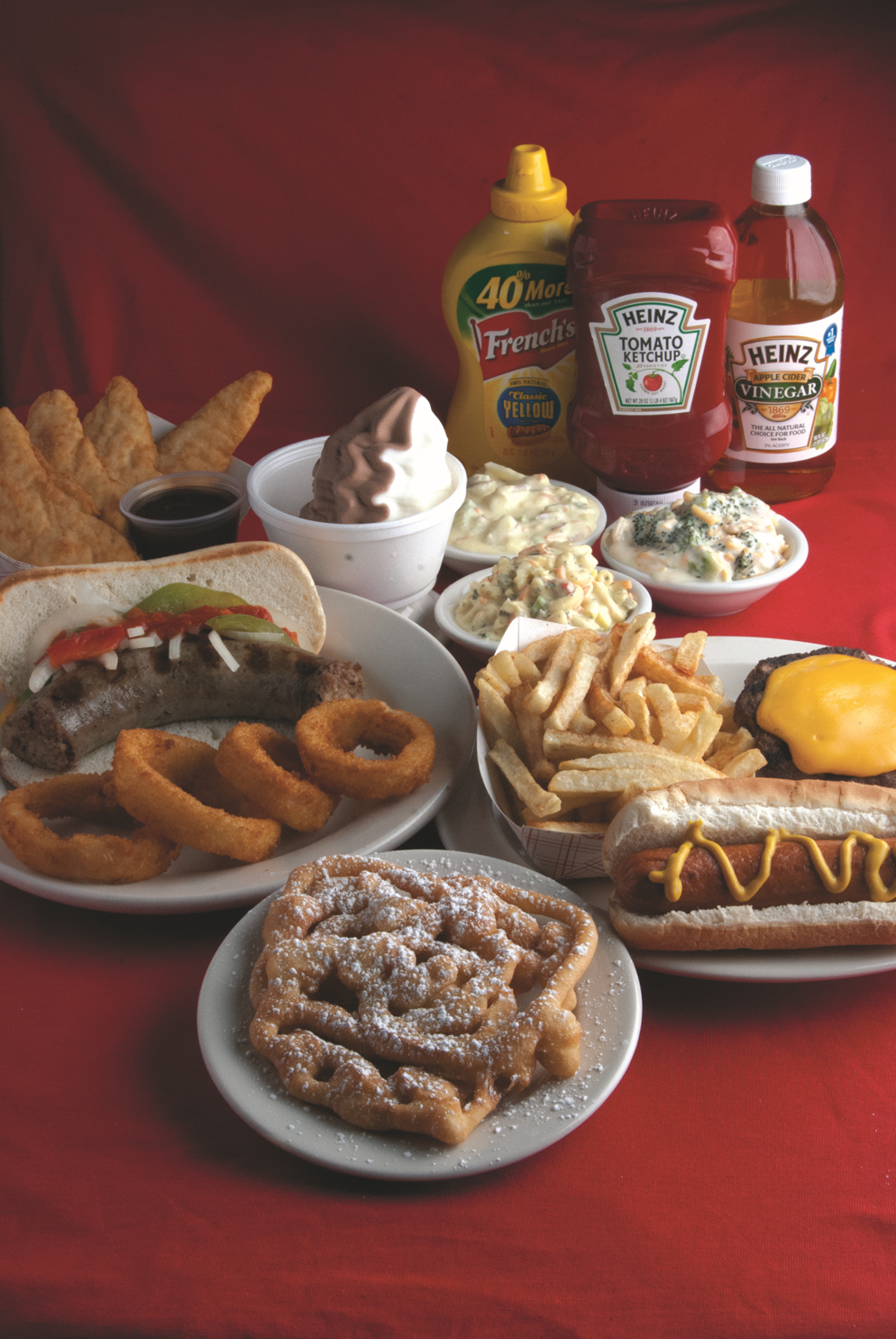 Plate of cheesesteak fries topped with melted cheese, sautéed onions, peppers, and thin slices of steak.