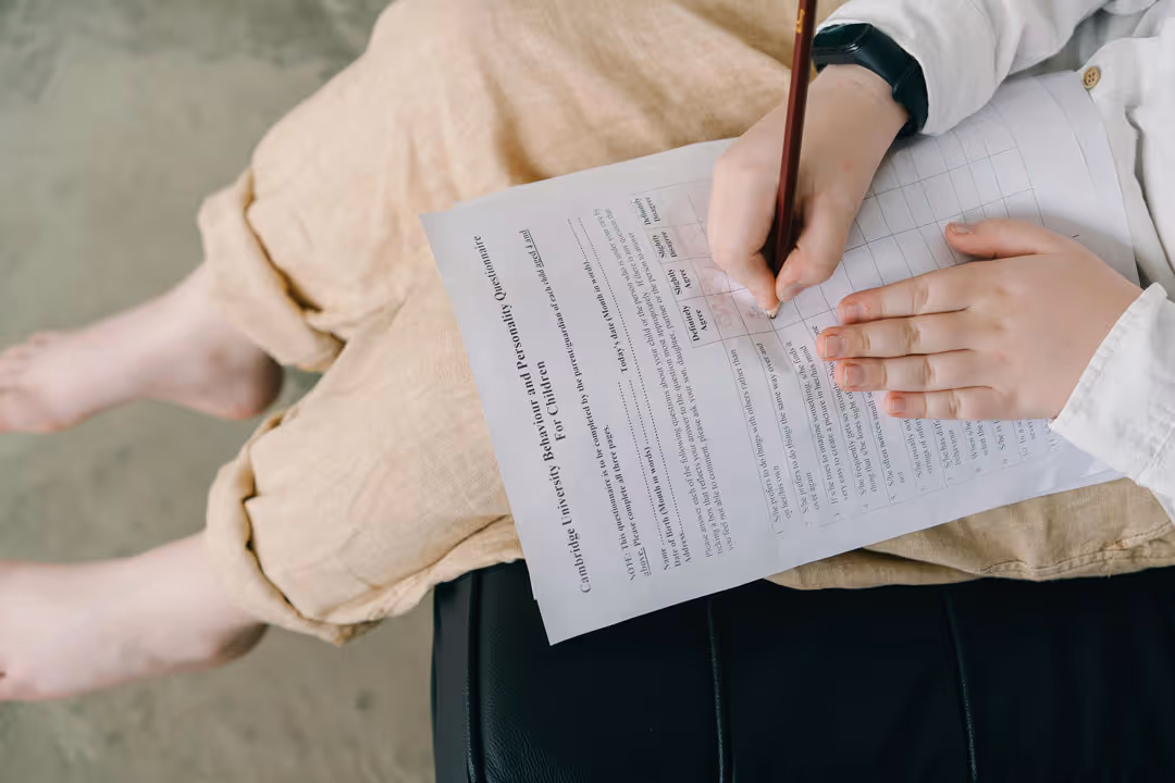 A child fills out a psychological questionnaire, representing the assessment process at Little Tree Psychology.