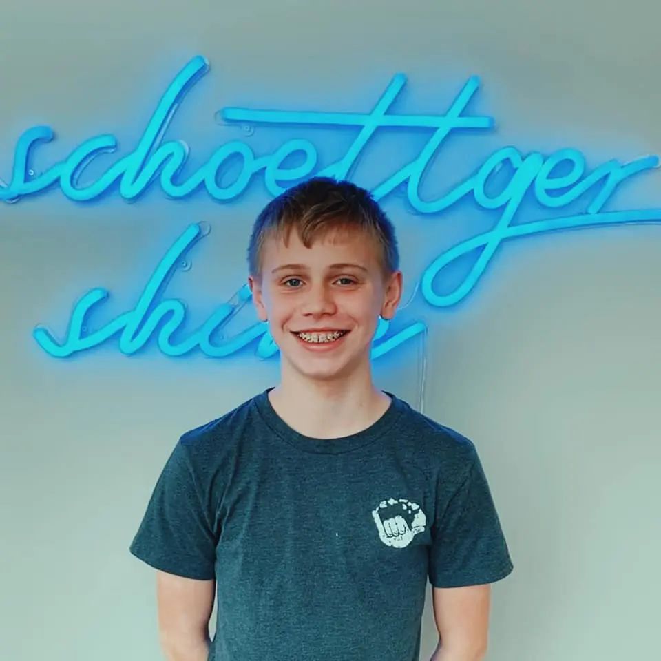 Schoettger Orthodontics patient celebrating smile transformation
