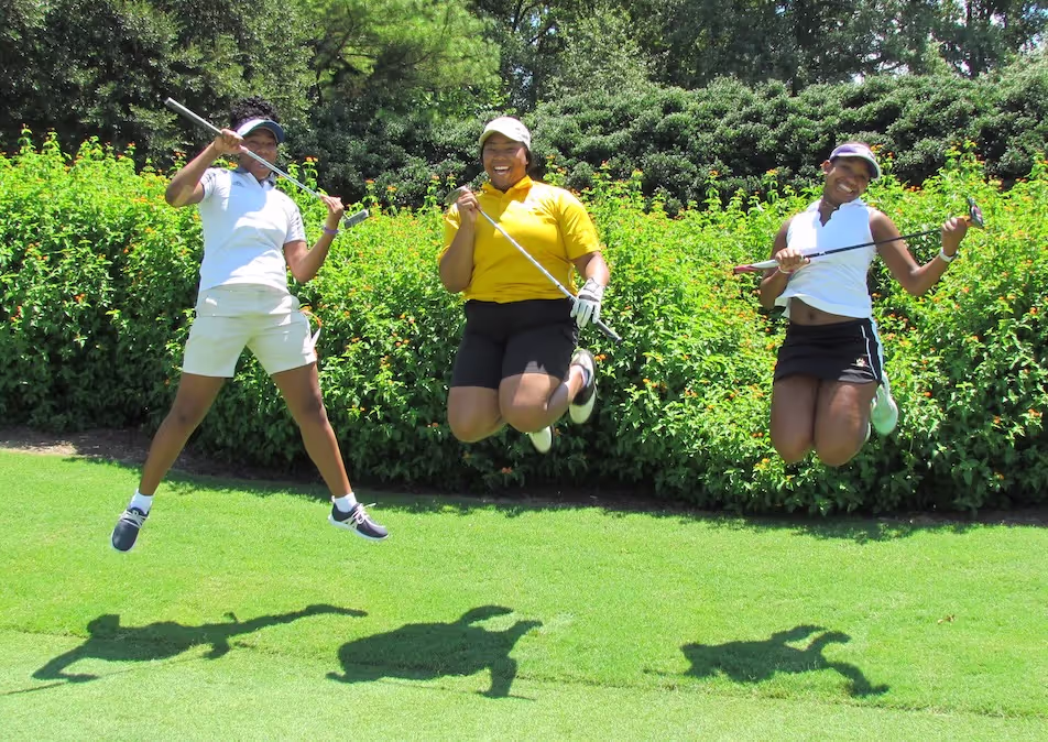 Golfers jumping for joy on the course