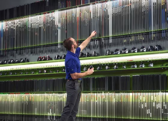 GOLFTEC Coach selecting shaft for club head in GOLFTEC center