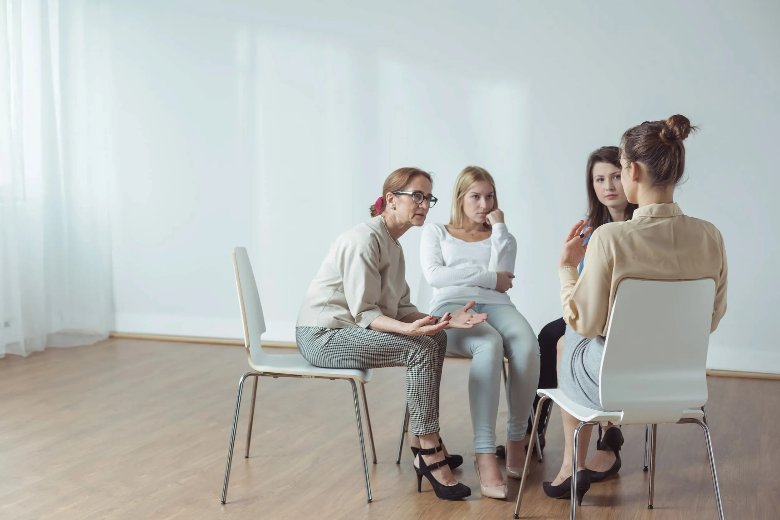 Facilitator leading a community support group discussion.