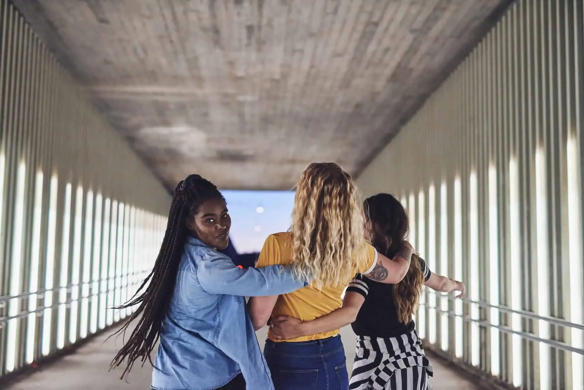 A group of women walking down a walkway.