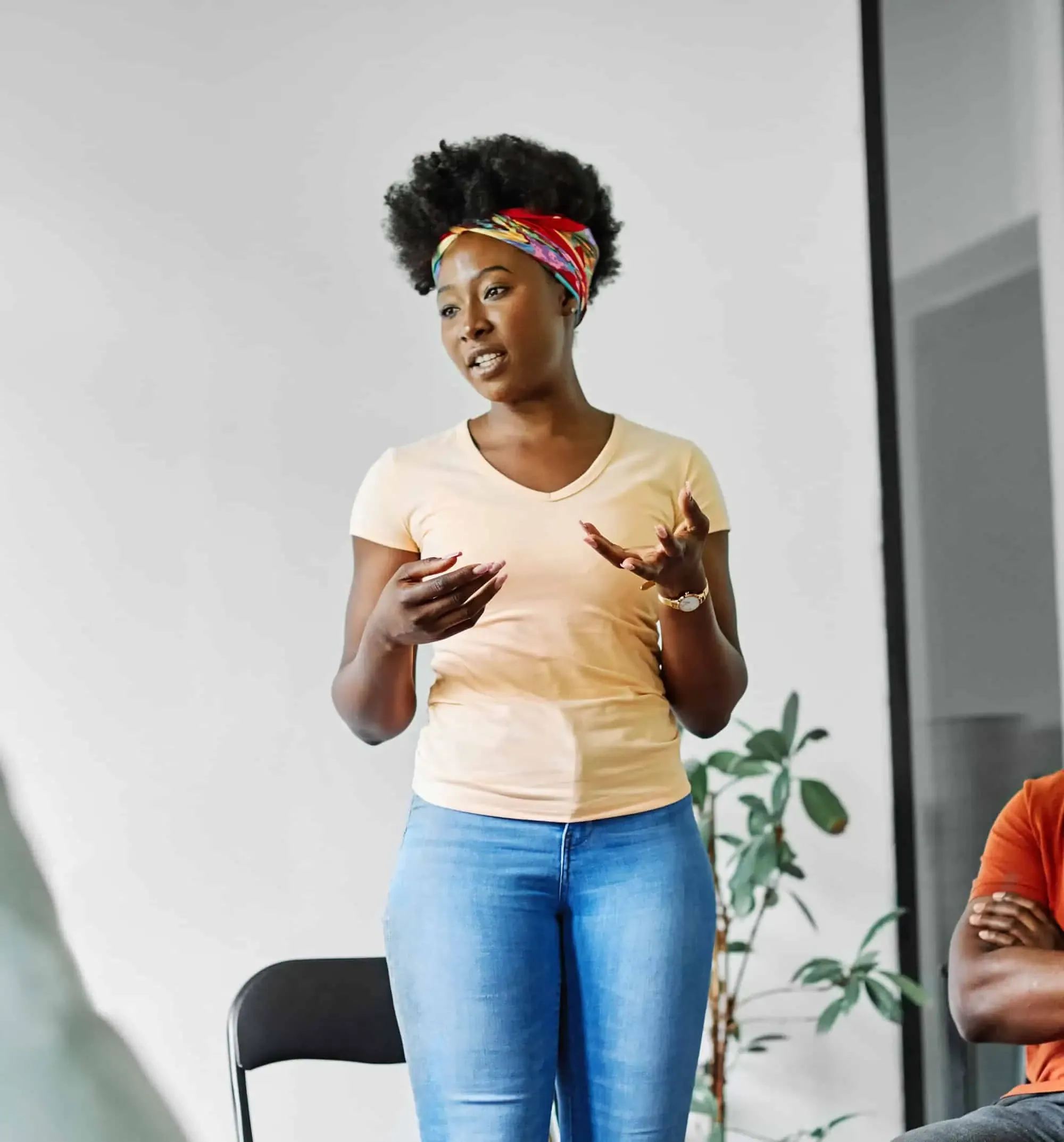 A woman standing in front of a man in a chair.