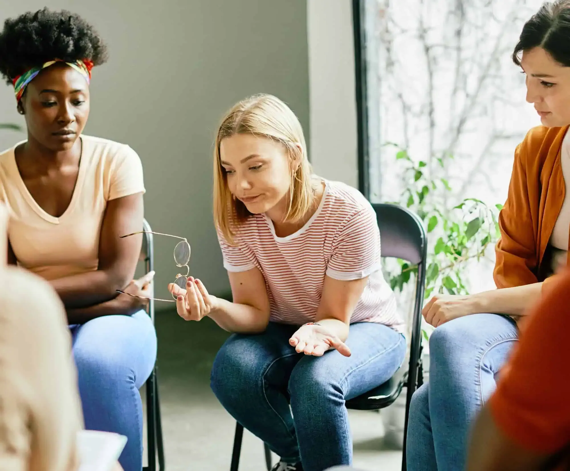 A group of women sitting around each other.