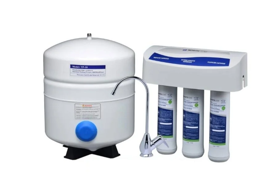 Home water filtration system with a white pressurized storage tank, three filter cartridges, and a chrome faucet.