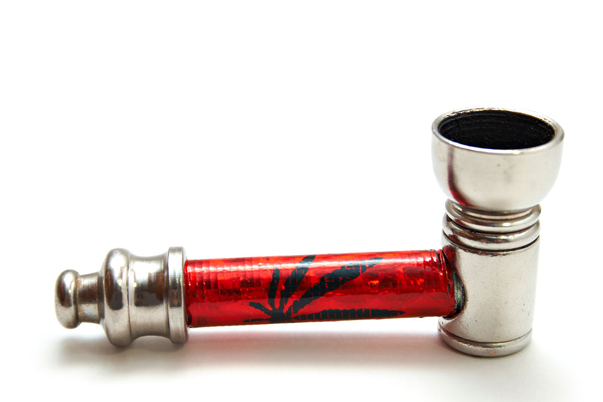 Metal cannabis pipe with a red tube