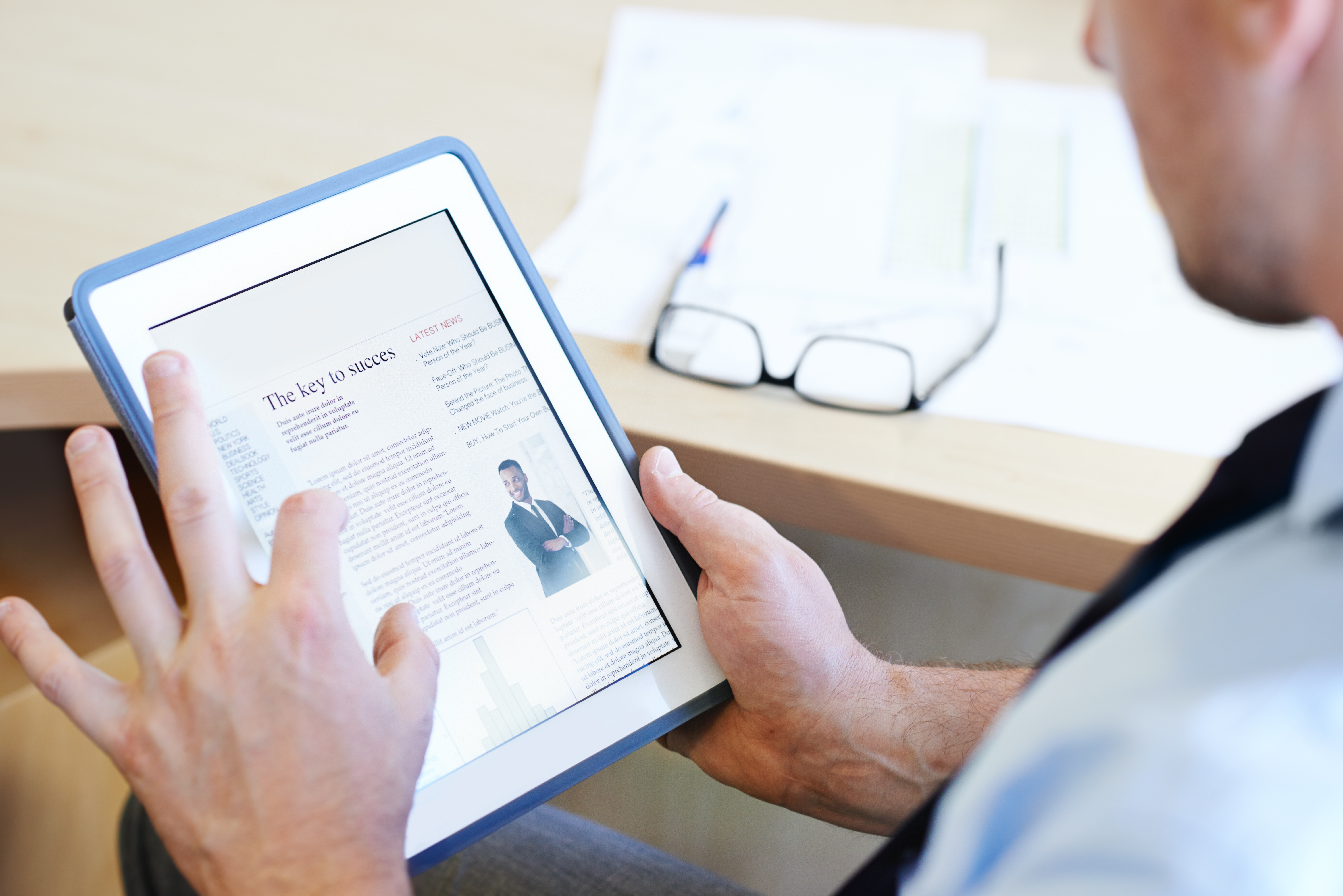 Business owner reading an article on maximizing business value and growth strategies
