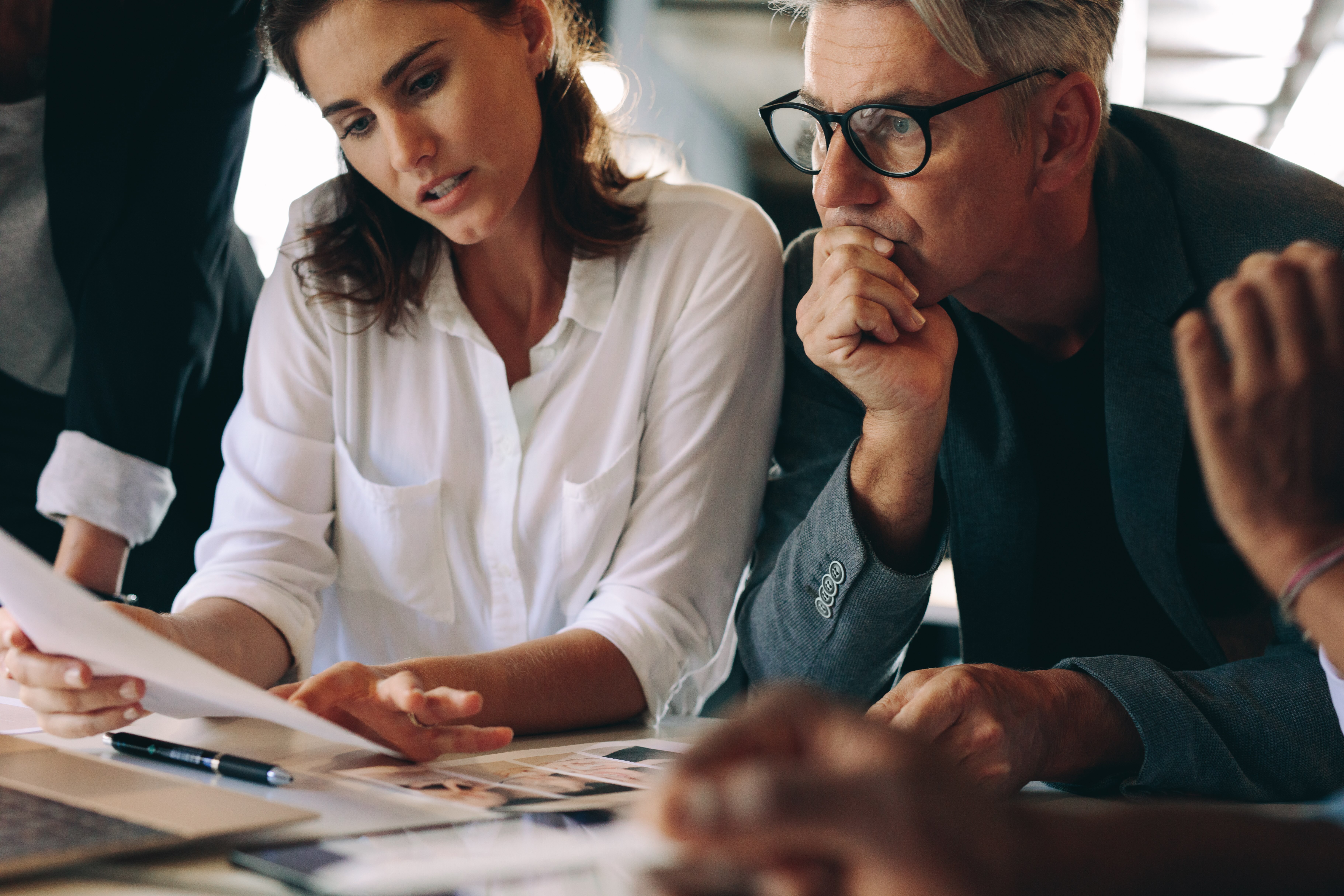 Business owners in a meeting addressing critical financial decisions they have been putting off