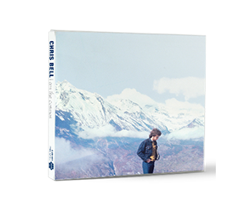 Album cover featuring a man standing in front of snow-covered mountains under a cloudy sky.