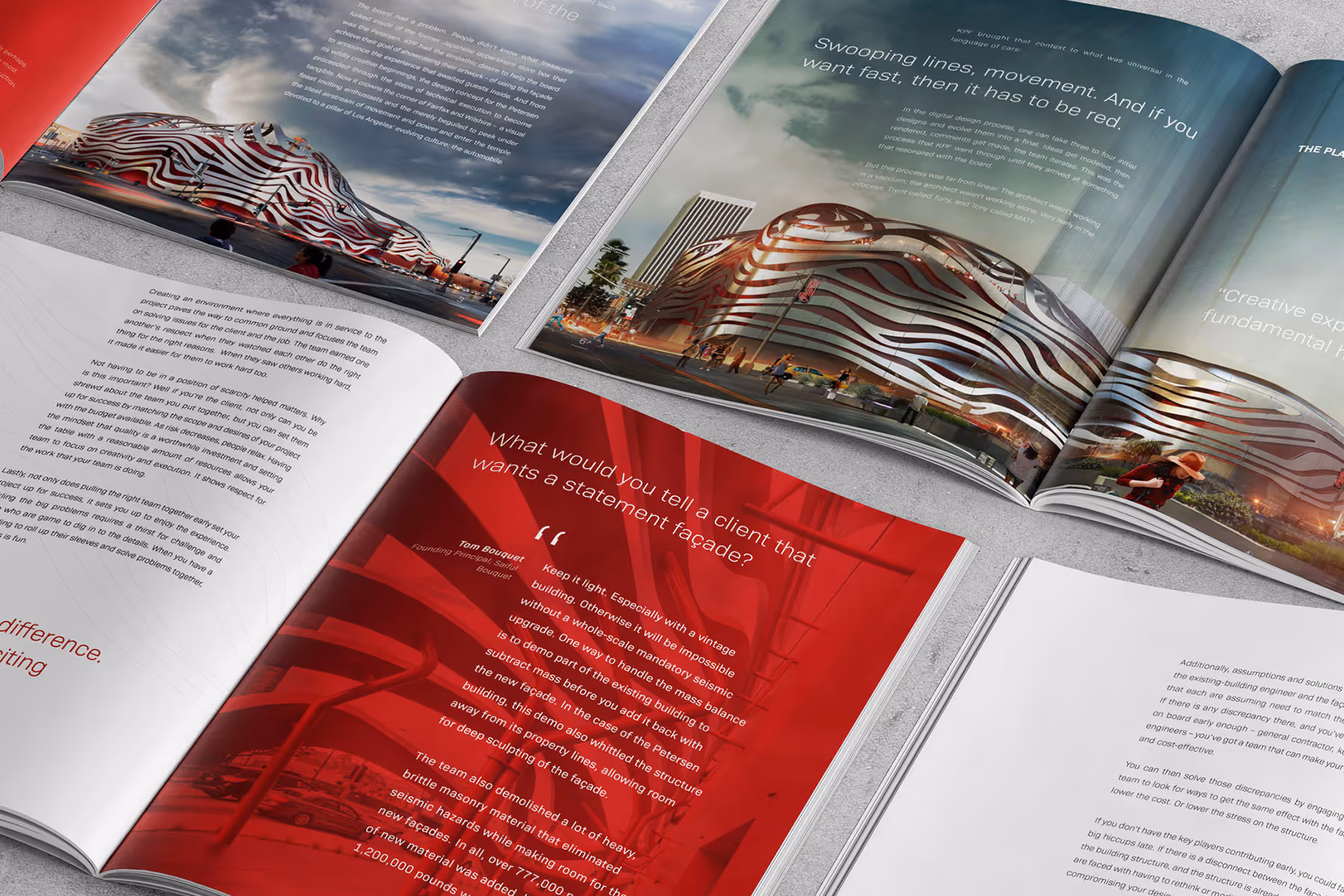 Open magazines displaying architectural designs and text, featuring a building with flowing red and white curved lines.