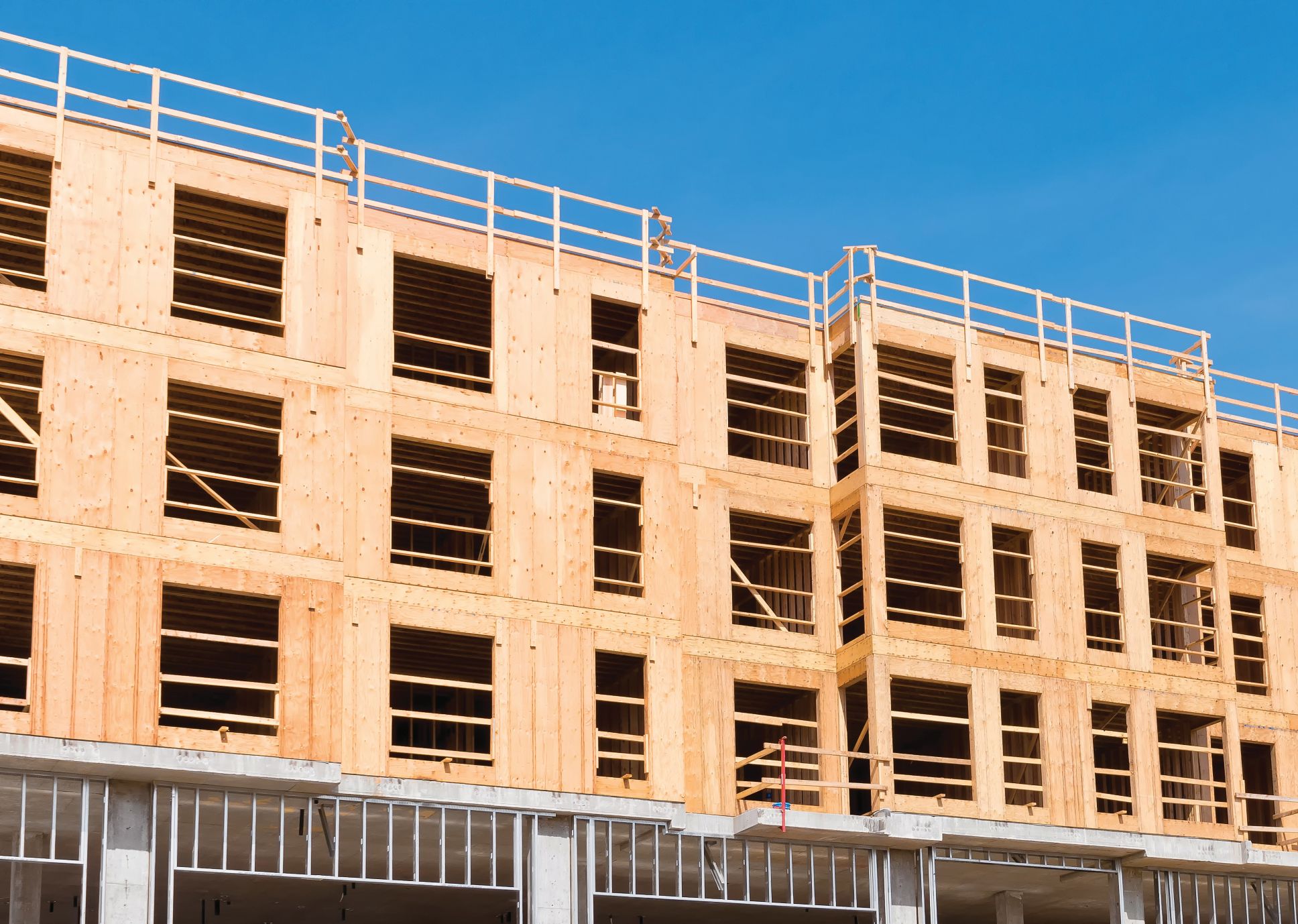 Residential building framed with fire-protected engineered wood