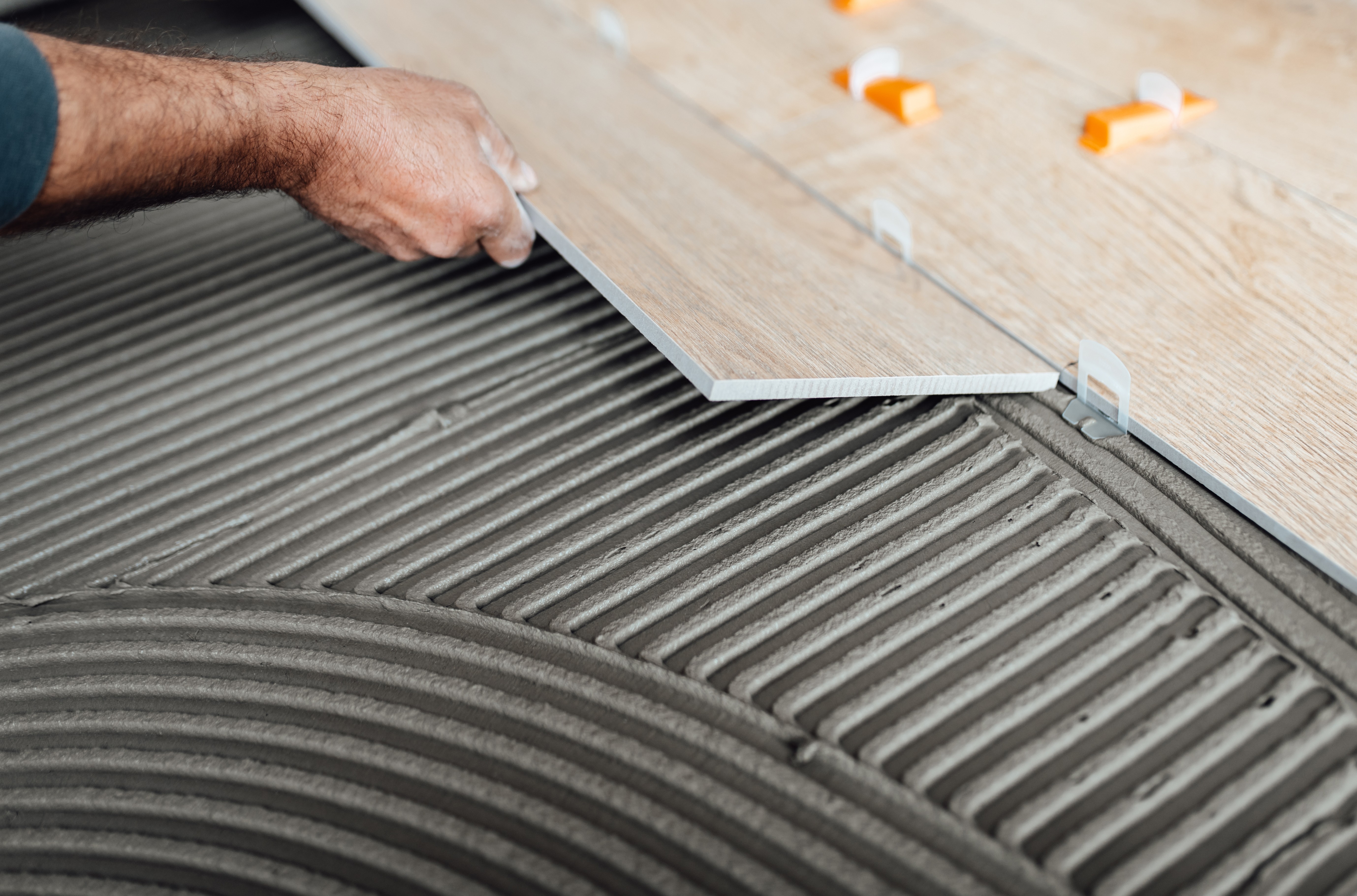 Adhesive being applied to a wood surface