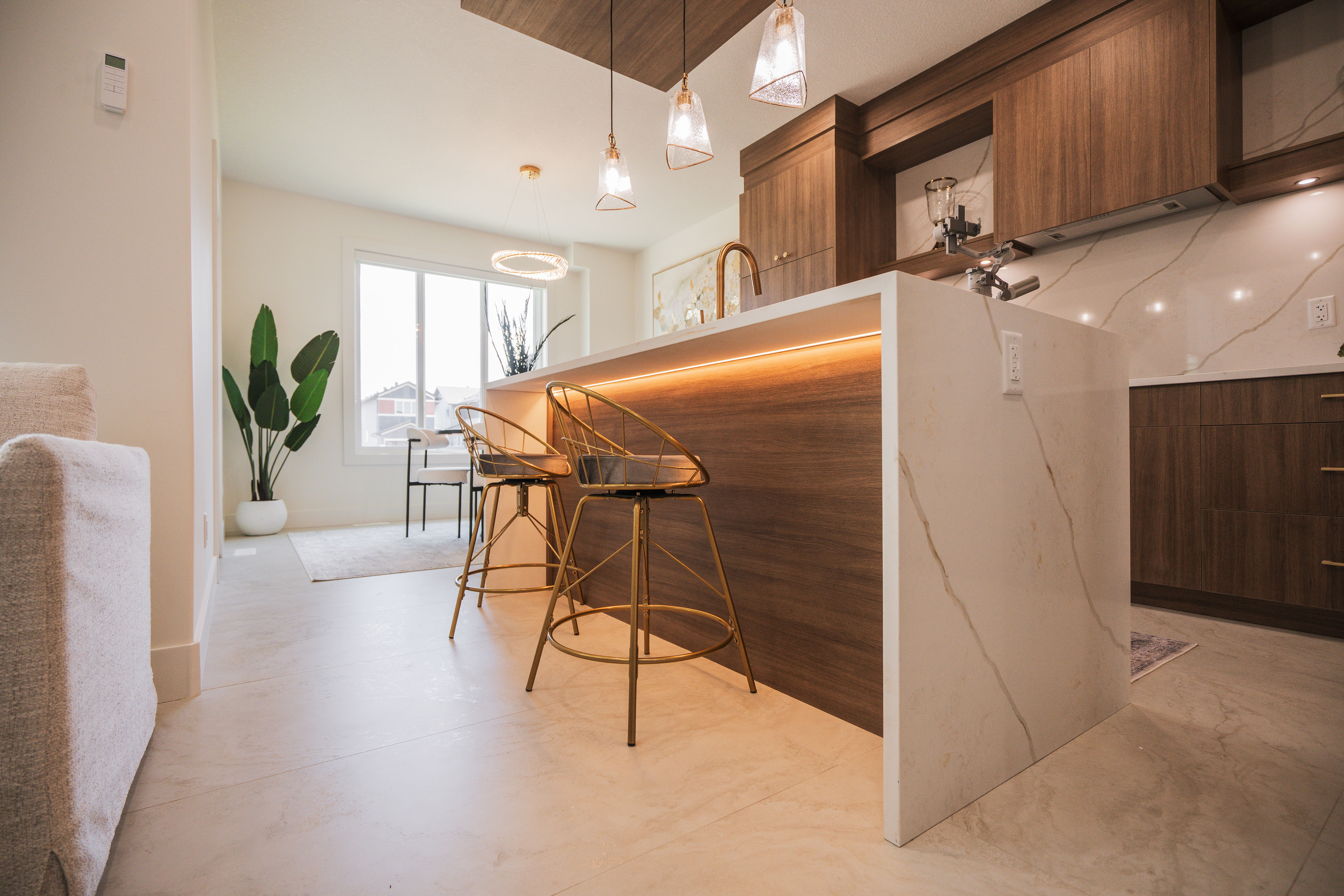 Hallway with wooden cabinets, white tiled floor, and a white door at the end.