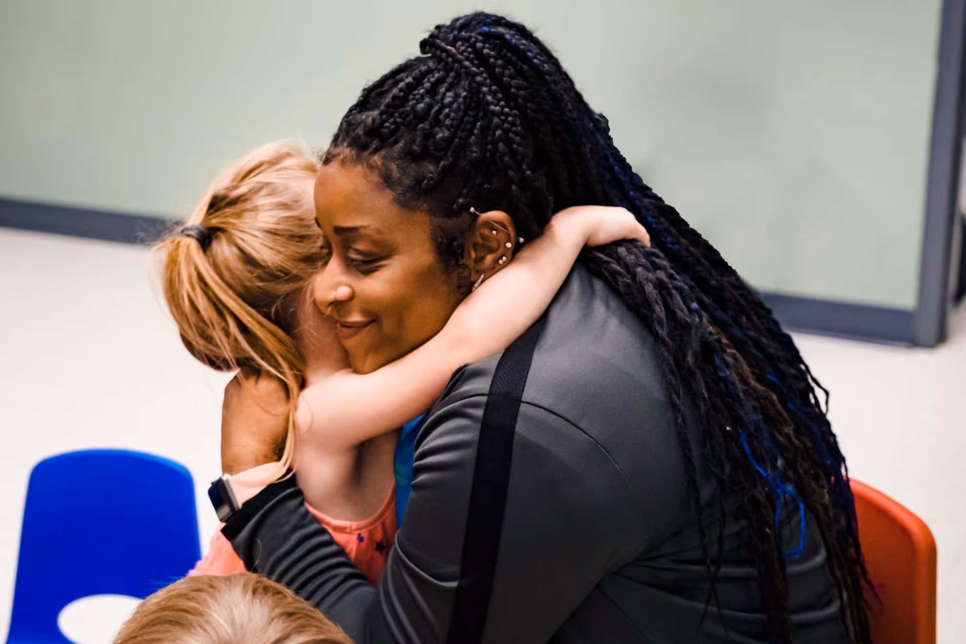 BIG team member hugging a child