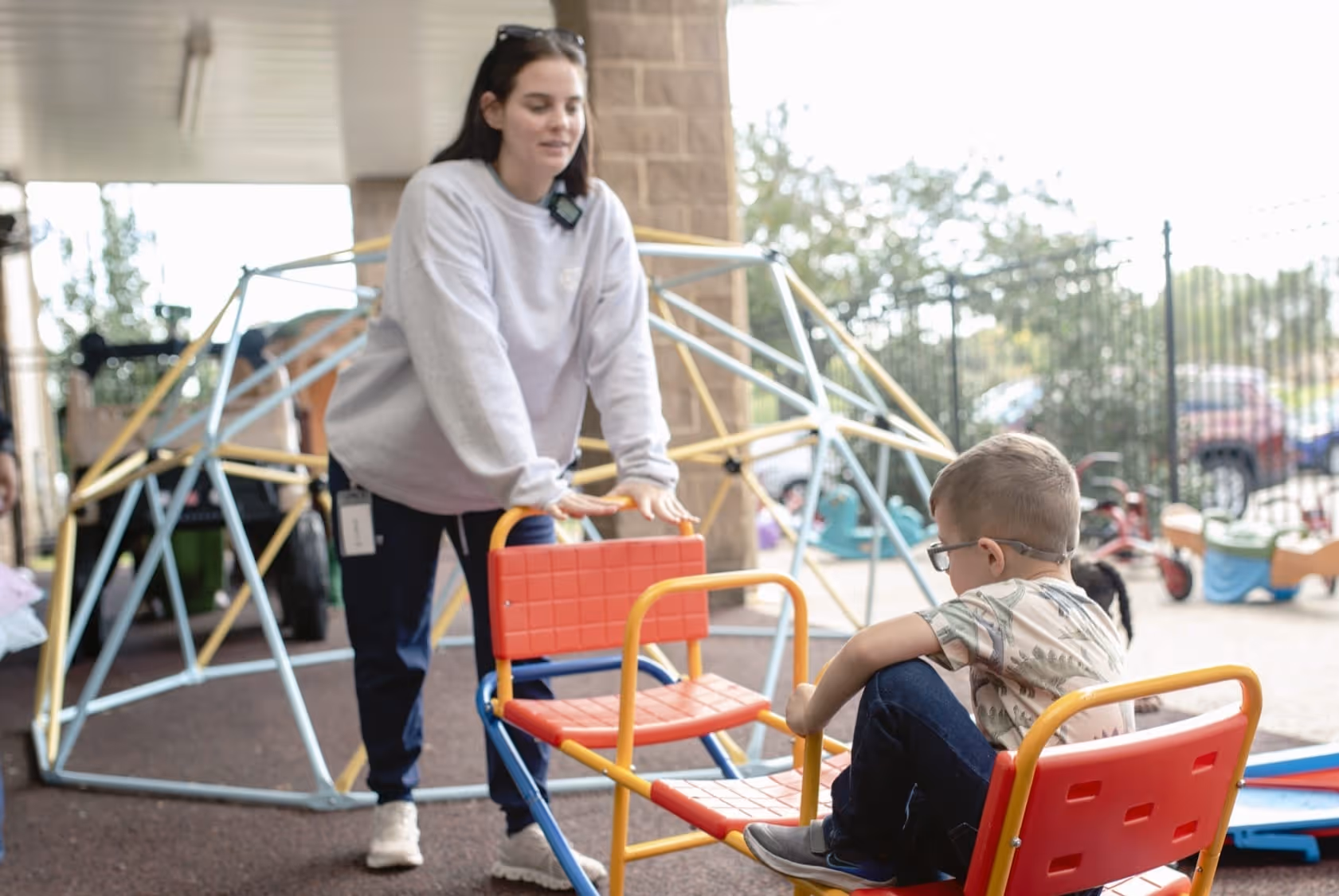 BIG staff playing on a seesaw with child