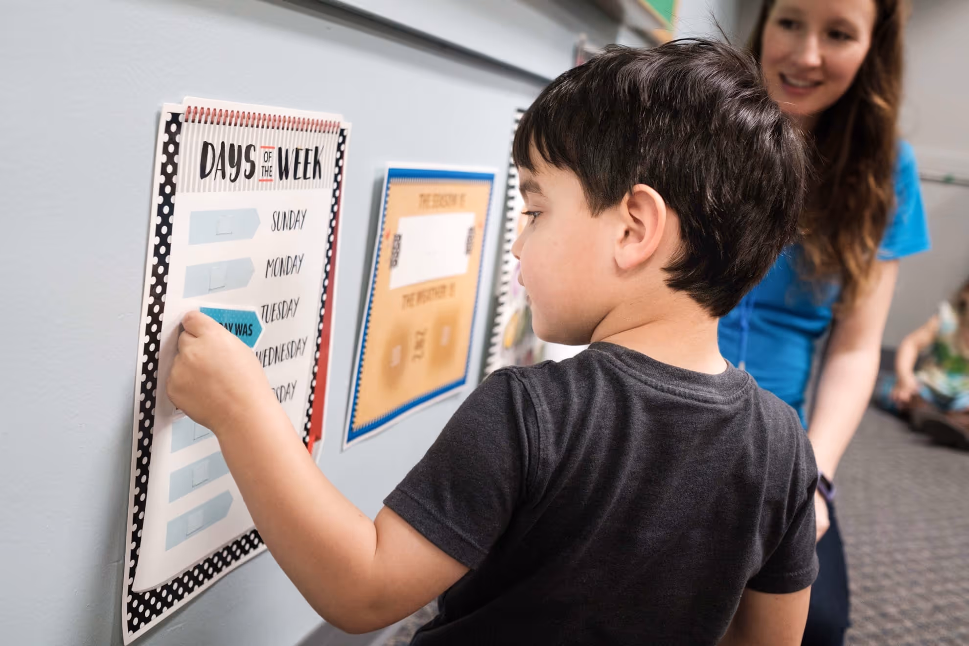 Child looking at learning toys on a table