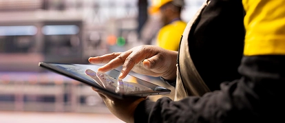 Inspector using a tablet for quality assurance on site
