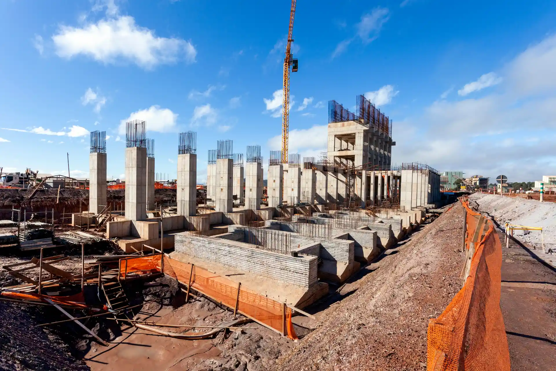 Construction site with rebar, concrete and orange netting