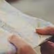 Close-up of hands holding and folding a face mask.