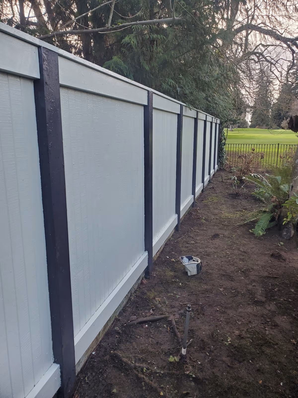 A fence painted grey and black in Eugene Oregon.