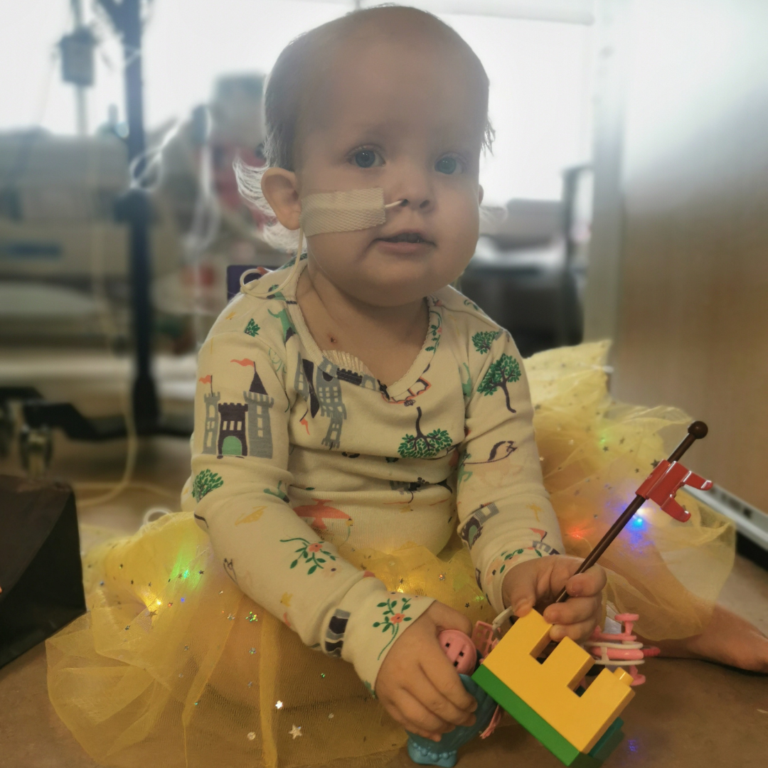 Photo of Claire in a hospital bed.