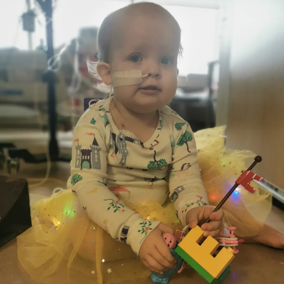Photo of Claire in a hospital bed.