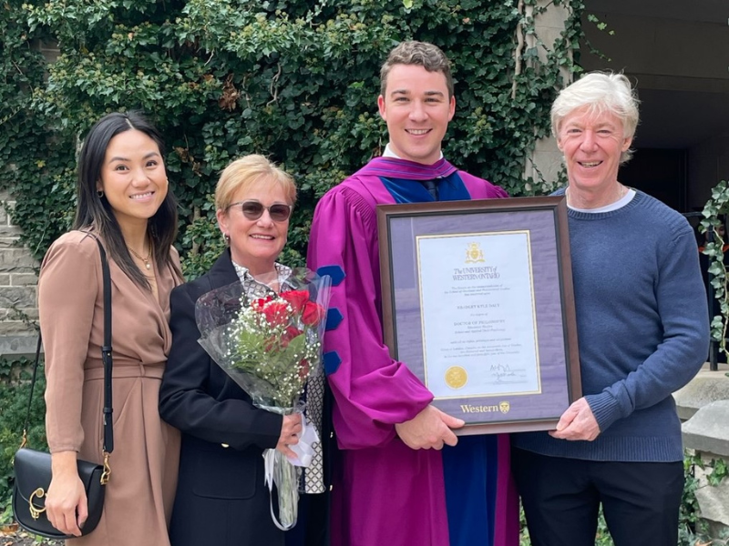 Brad's post-secondary graduation photo with his friends and family
