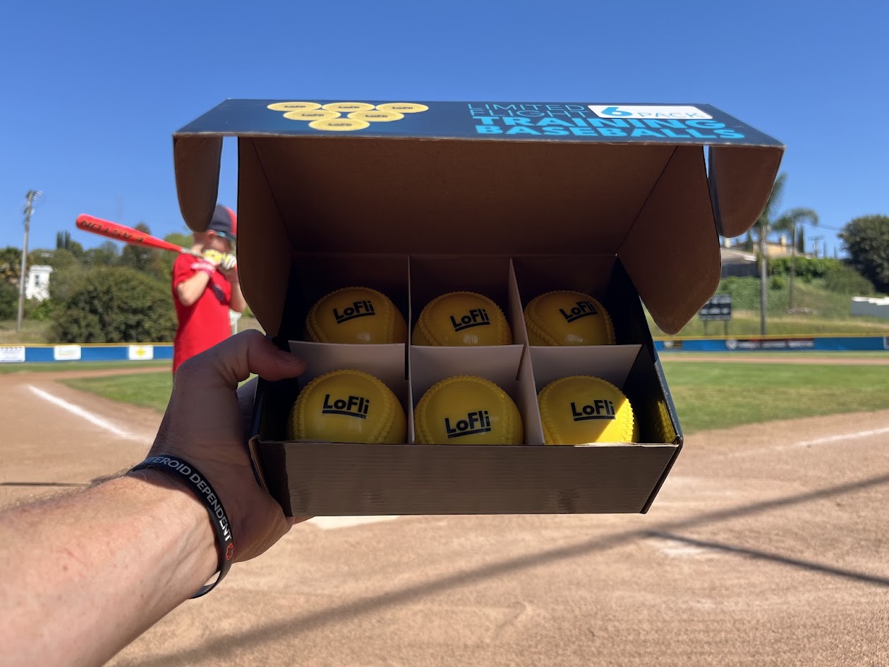 image of a 6-pack box of balls on the baseball diamond