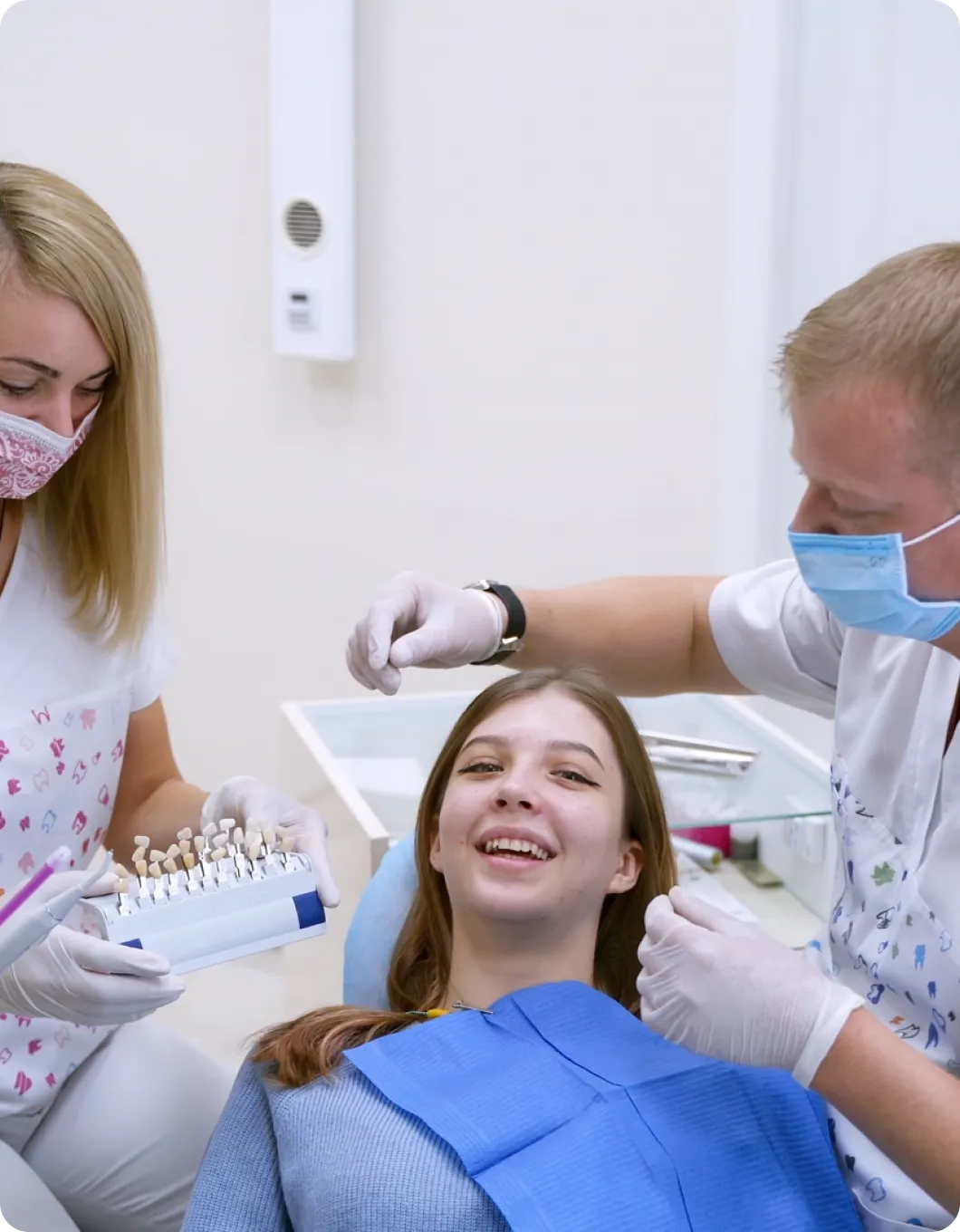 A woman getting her teeth checked by a dentist.