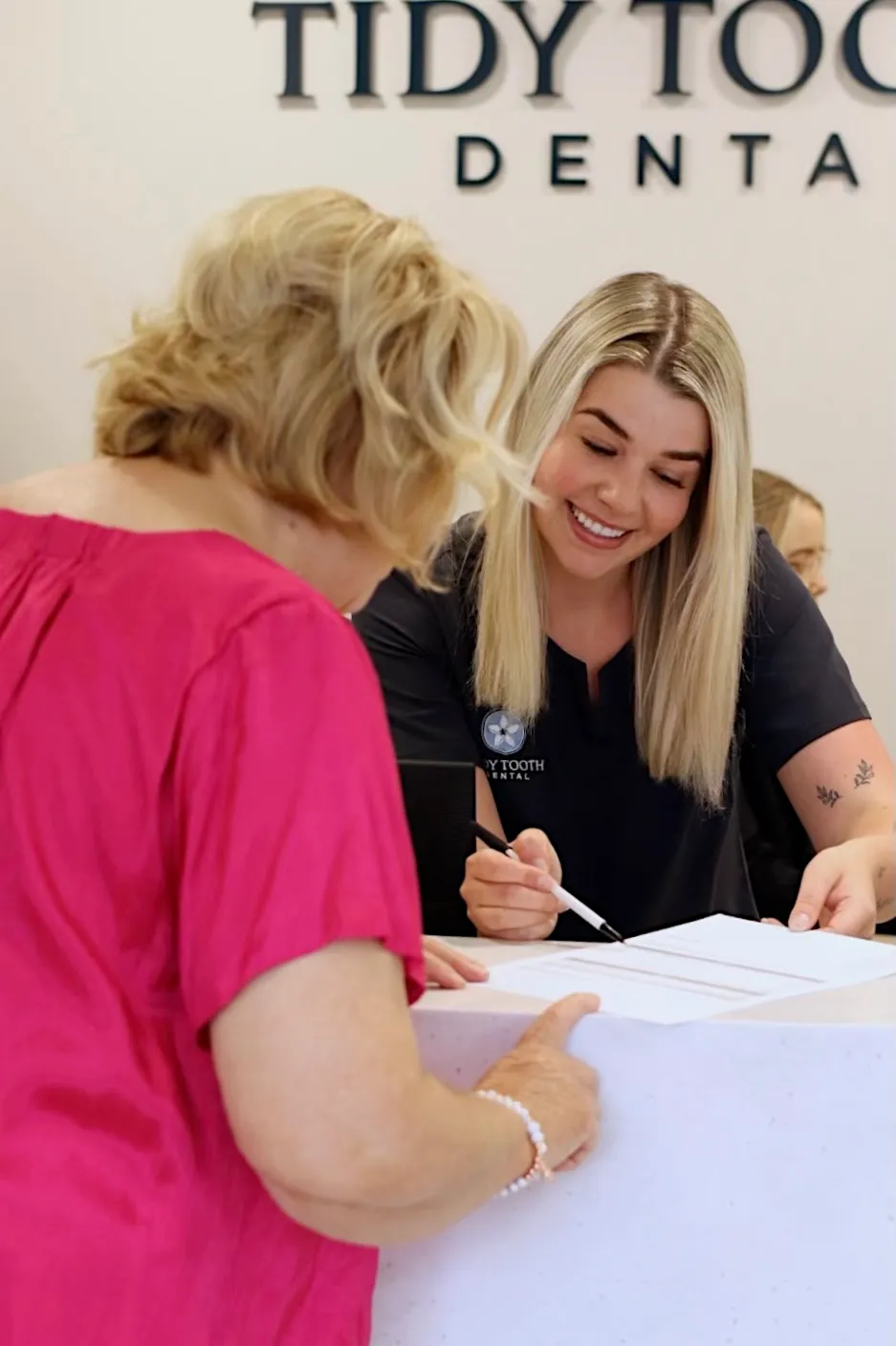 Tidy Tooth Dental team member explaining dental payment plan options