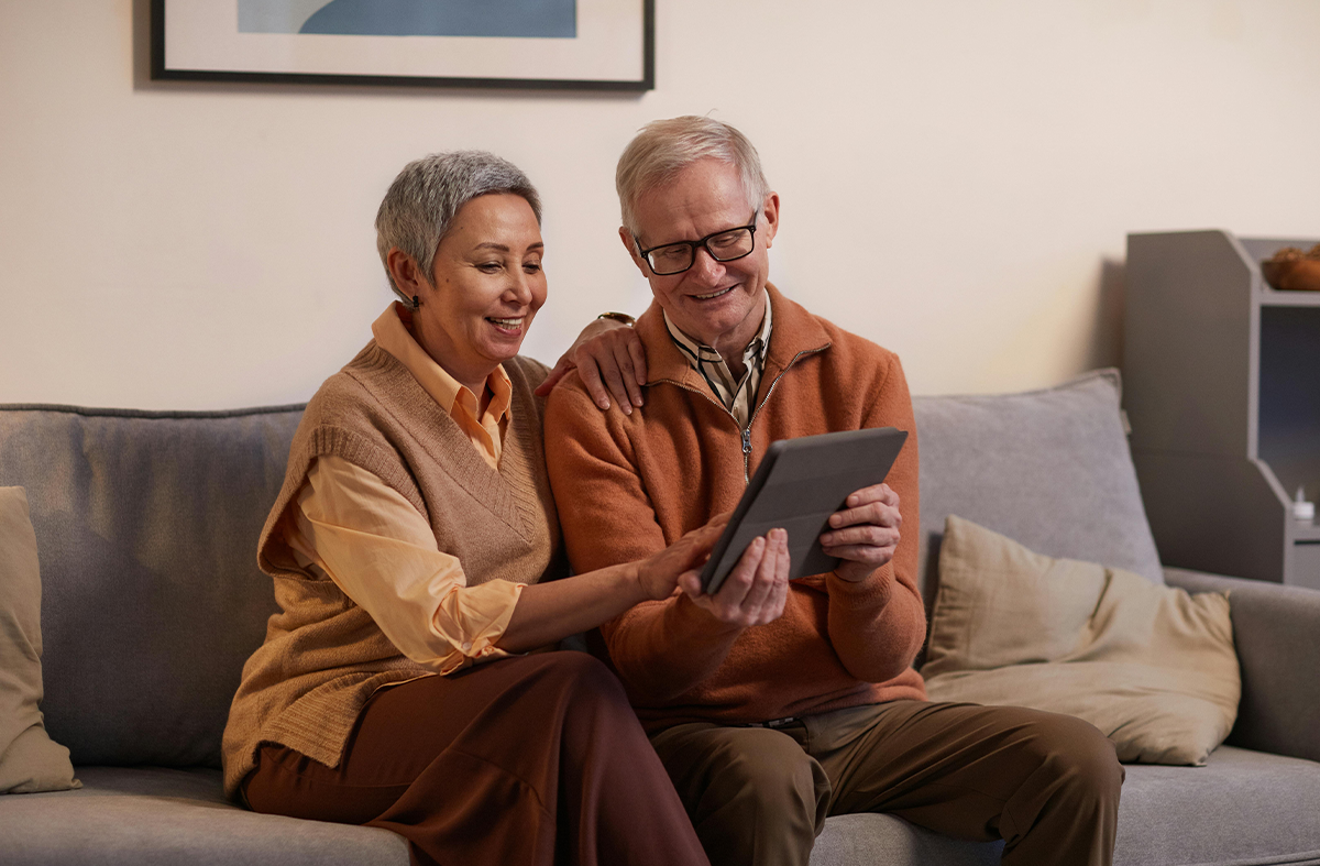 Old couple looking at tablet