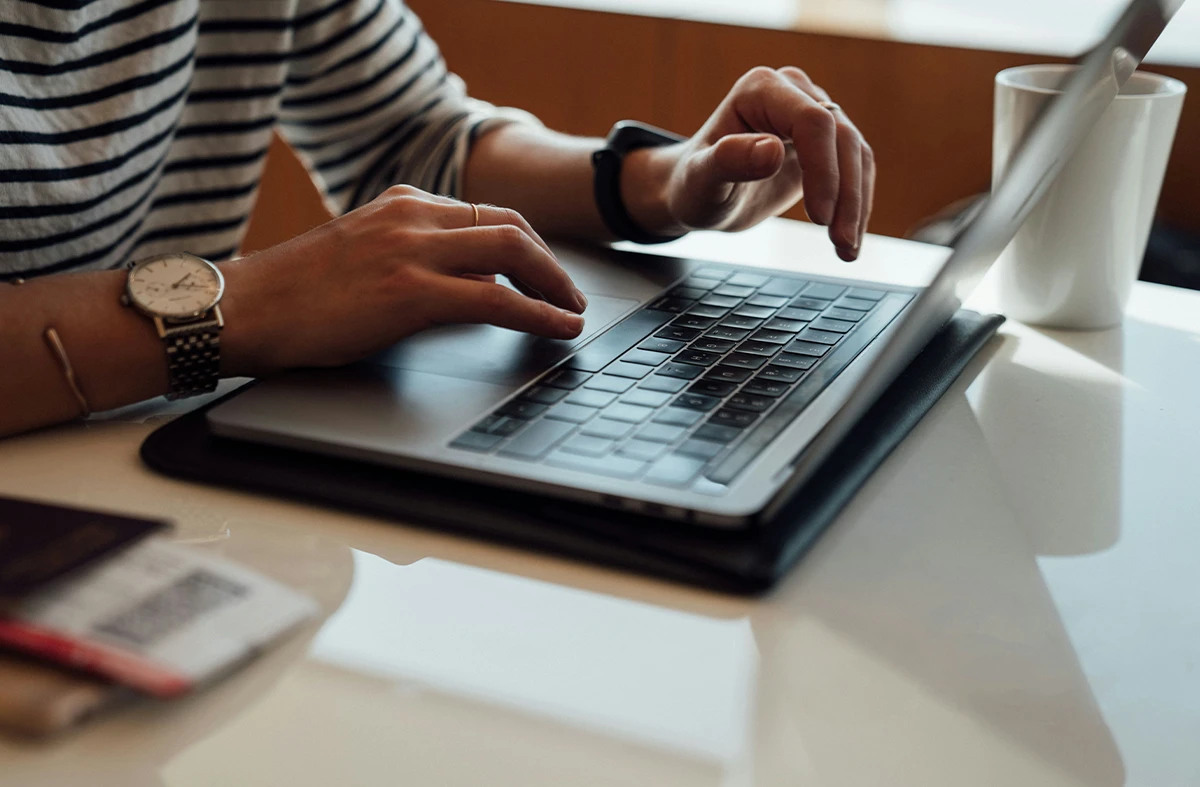 Close-up of handstyping on a laptop