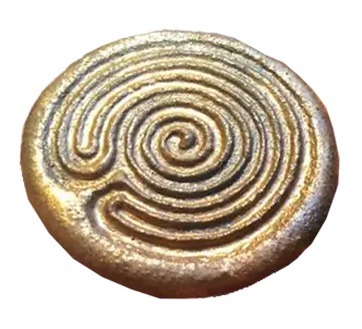 Metallic circular labyrinth medallion with a raised spiral maze design.