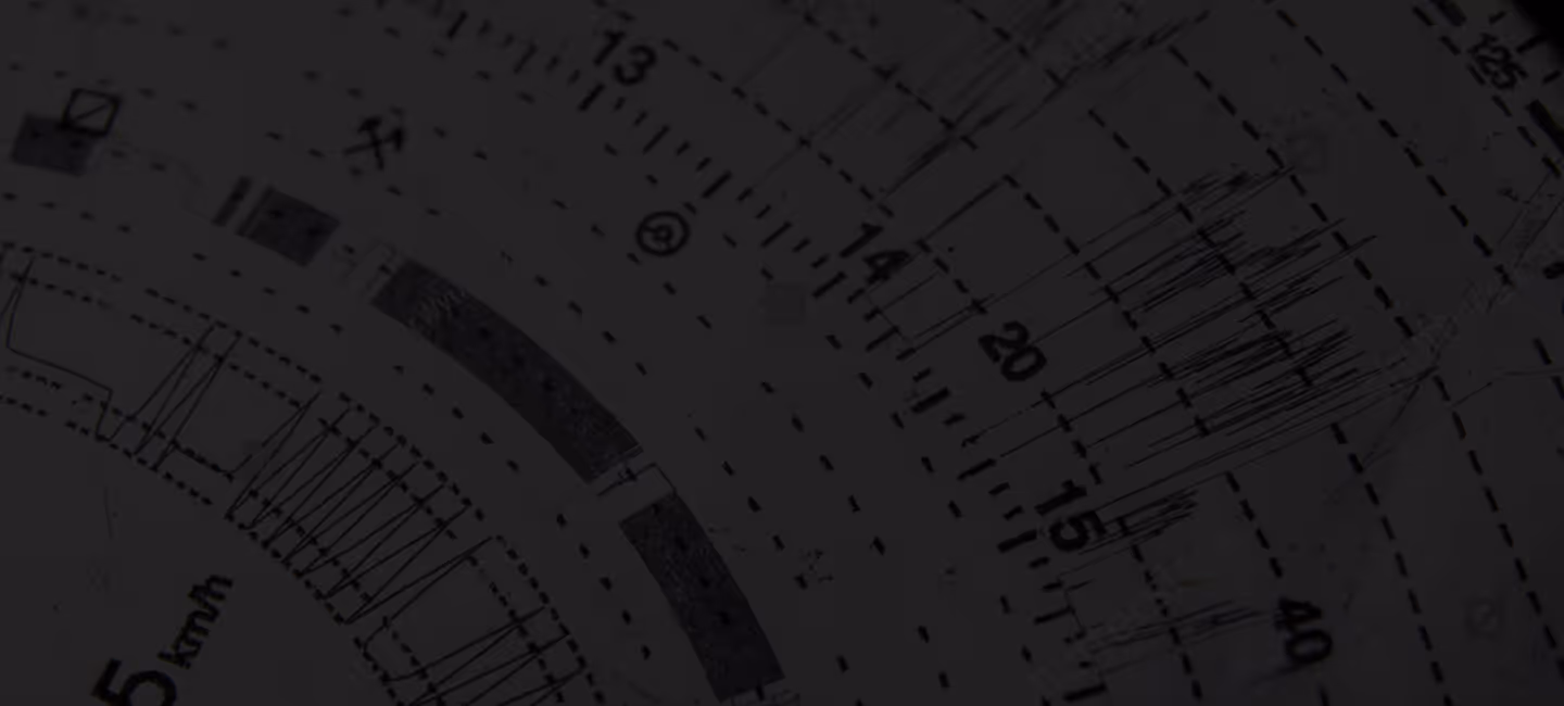 Close-up of a circular tachograph chart showing handwritten data lines, with time and distance markings around the edge.