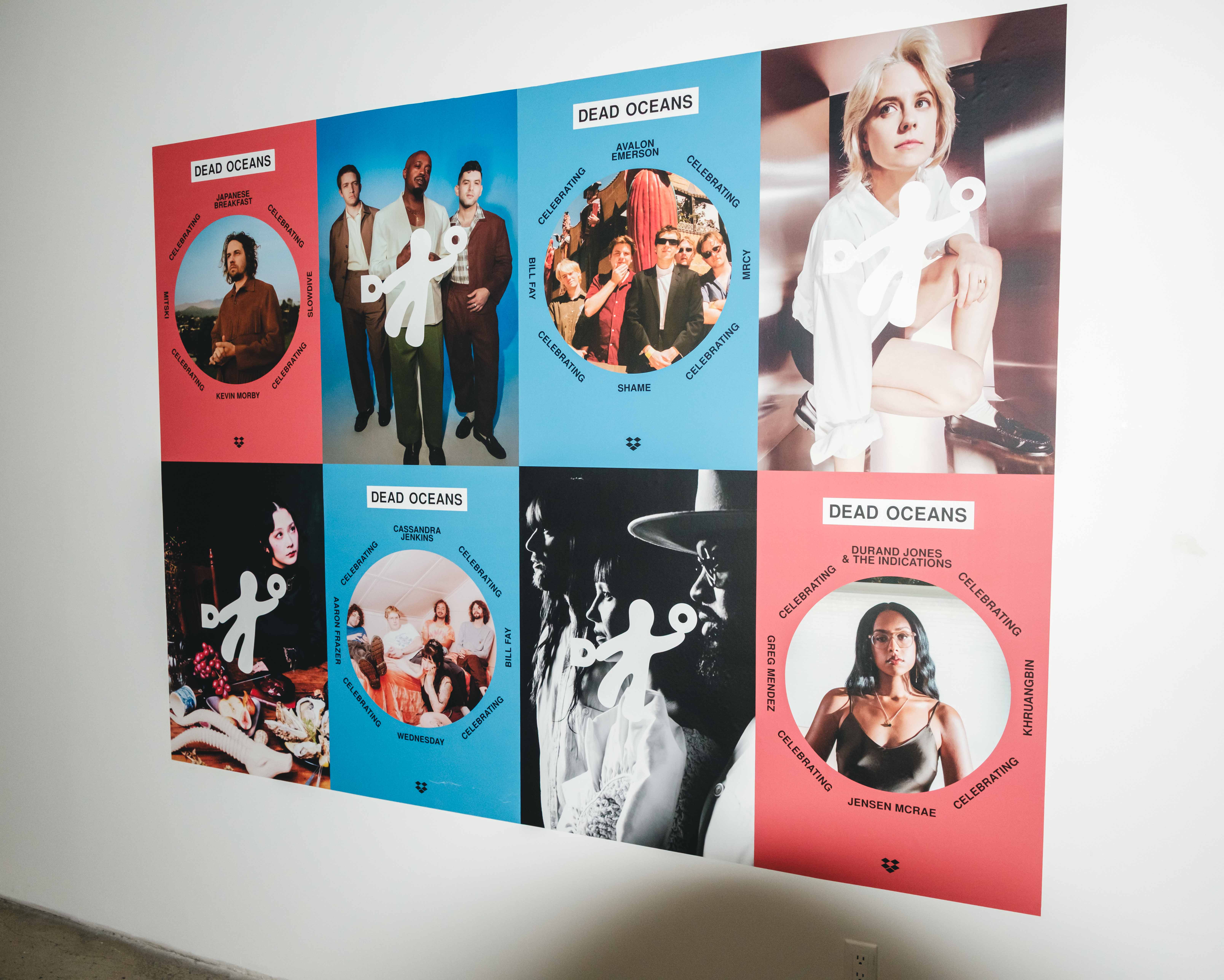 Large wall poster made of six colorful panels arranged in two rows of three, each labeled “DEAD OCEANS”