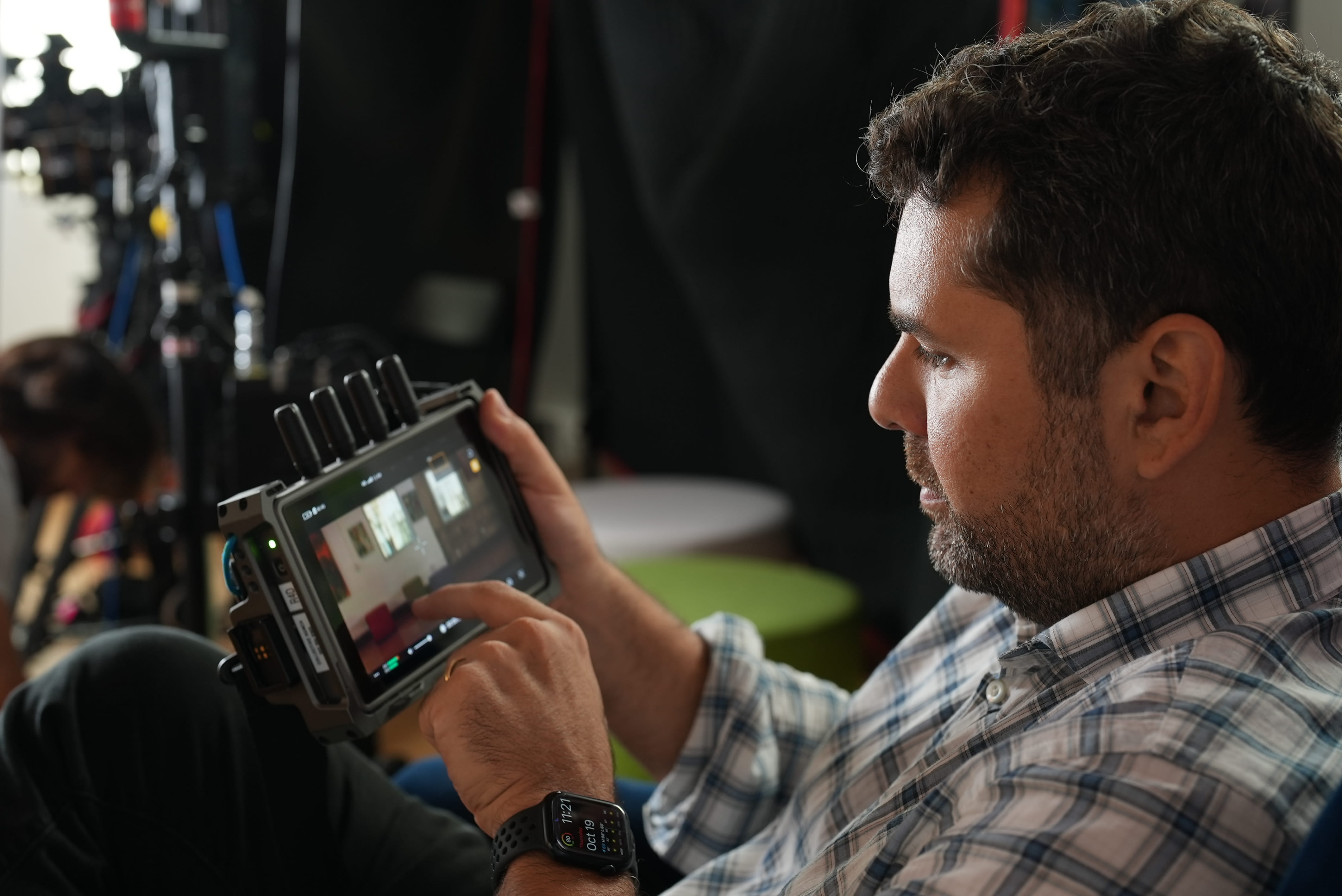 Man holding and using a handheld monitor device